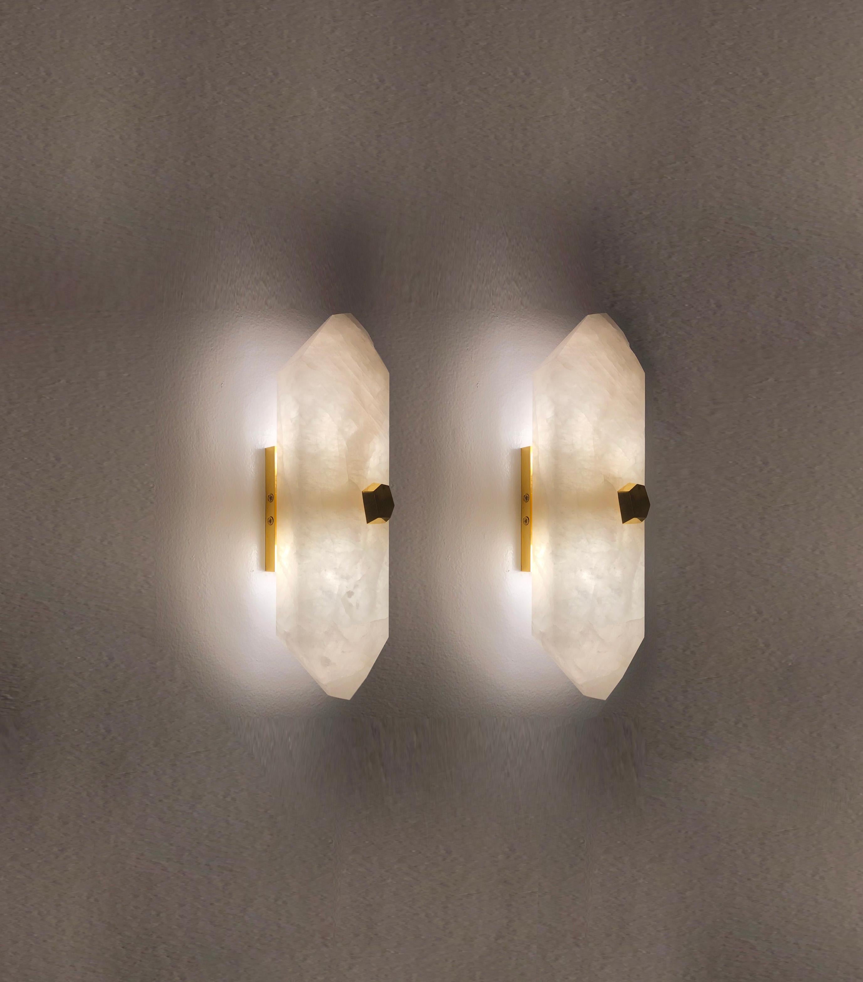 Pair of carved diamond from rock crystal sconces with the polish brass mount. Created by Phoenix Gallery NYC.
Each wall sconce is installed with two sockets, 40 watts max each socket, the total of 80-watt maximum. 
Custom size upon request.