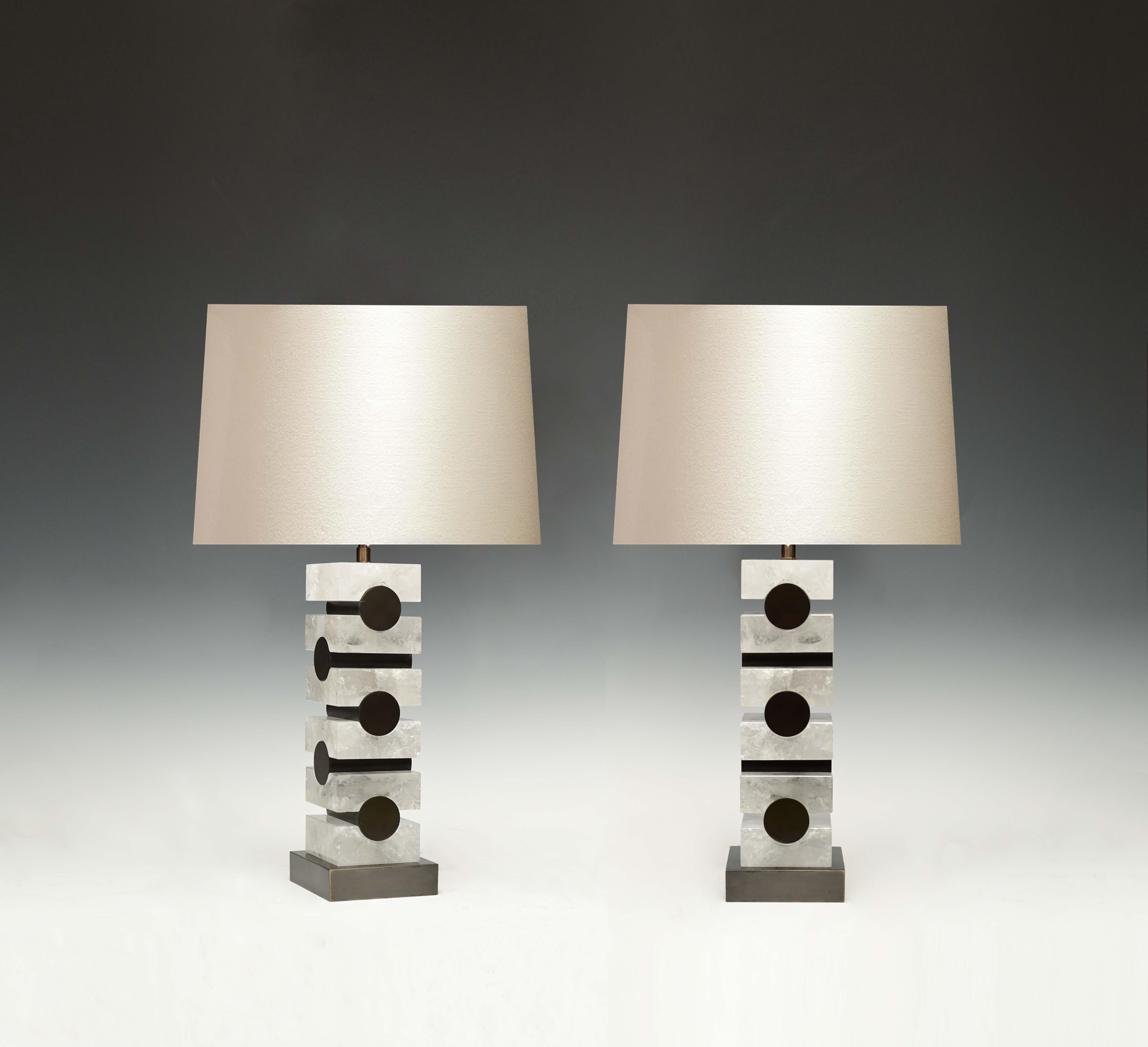 A pair of modern cubic style rock crystal lamps with antique brass inserted decoration. Created by Phoenix Gallery.
To the top of the rock crystal 14.5in.
Two sockets installed in each lamp.
Lampshade do not included.