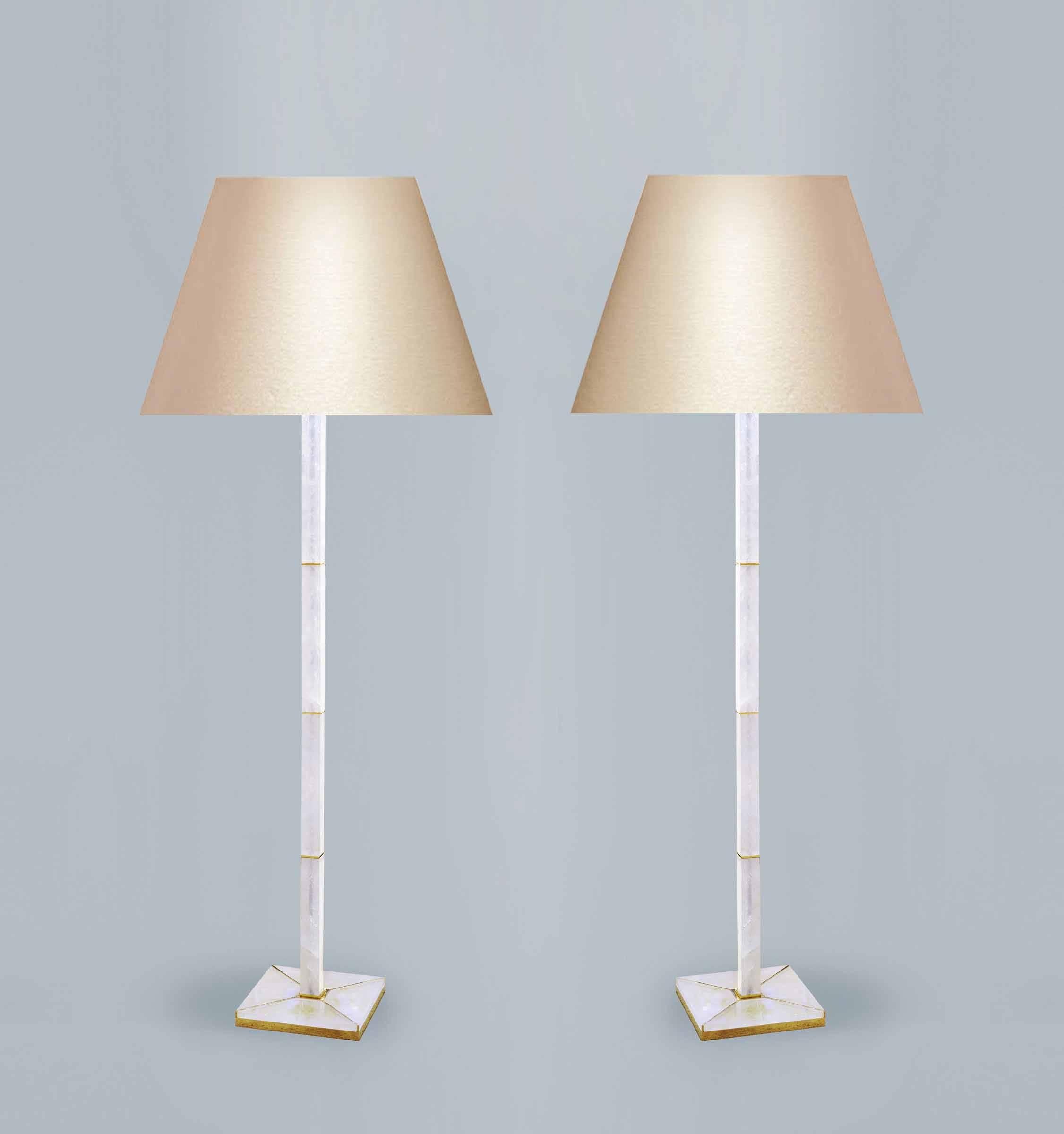 Pair of fine carved square column rock crystal floor lamps with a gilt metal base, created by Phoenix Gallery, NYC.
(Lampshade not included).
