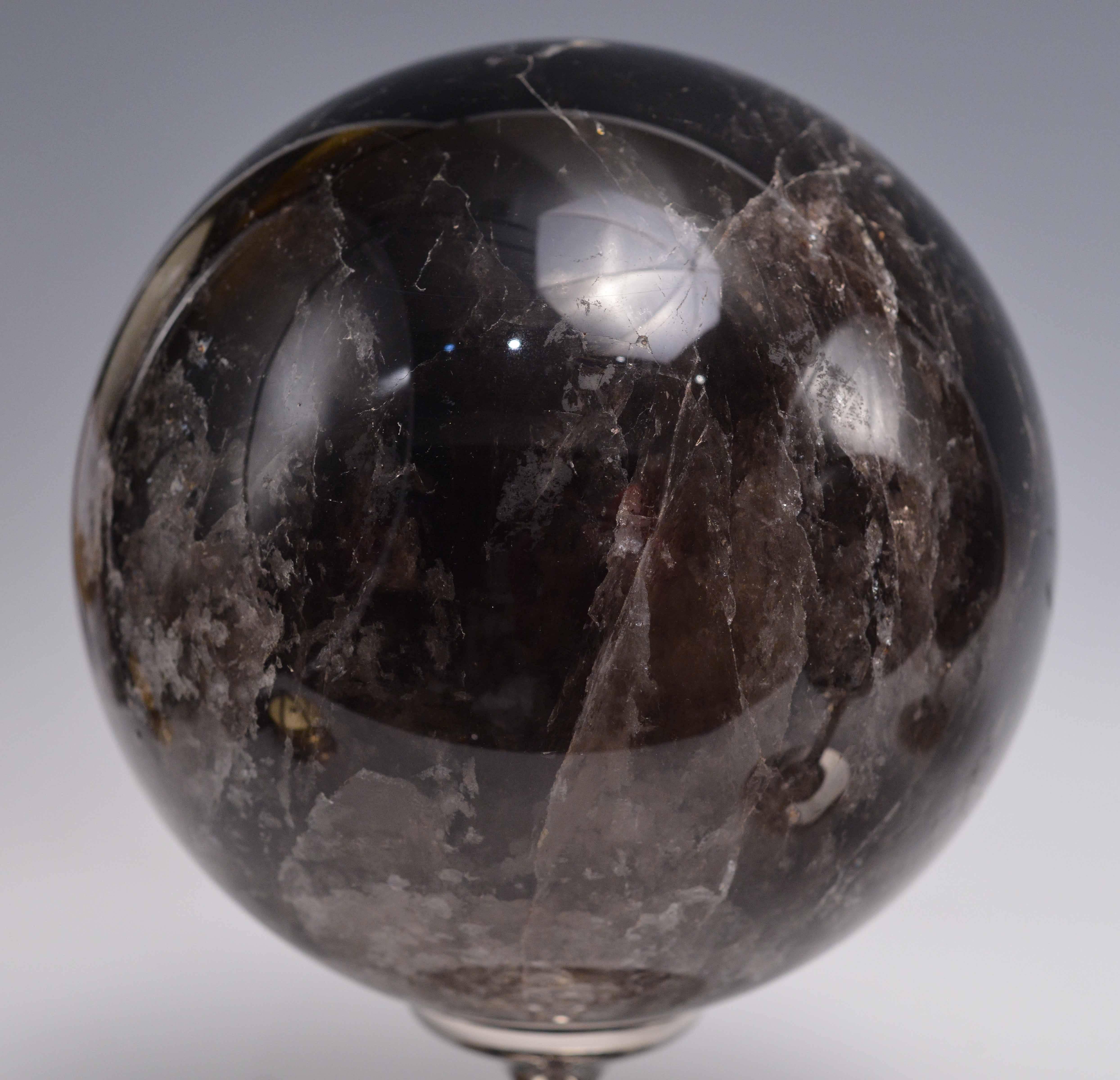 A group of three dark rock crystal balls with nickel plating bases.

Measure: (from left to right)
10