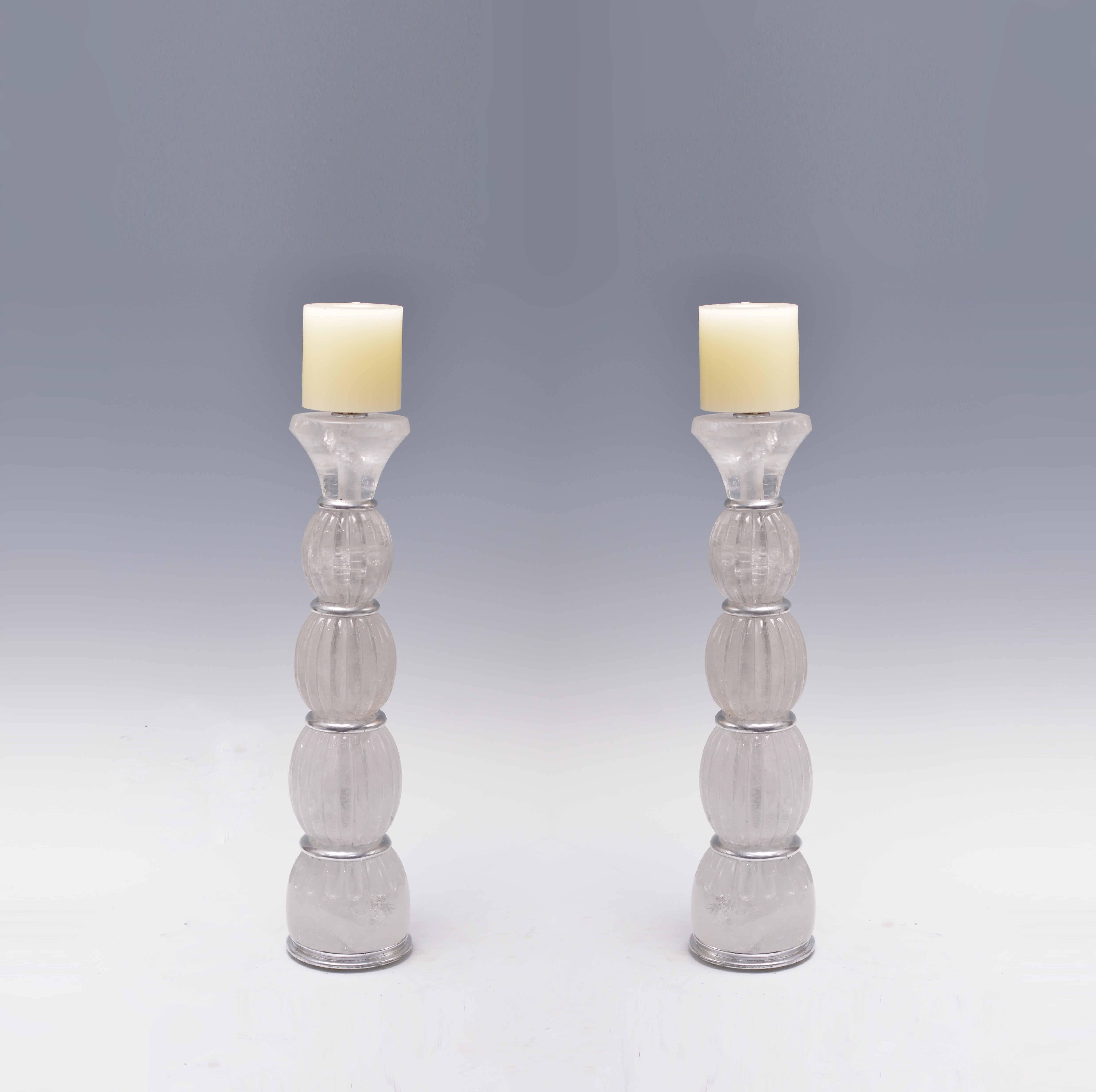 A pair of fine carved ribbed rock crystal quartz candle holders.

