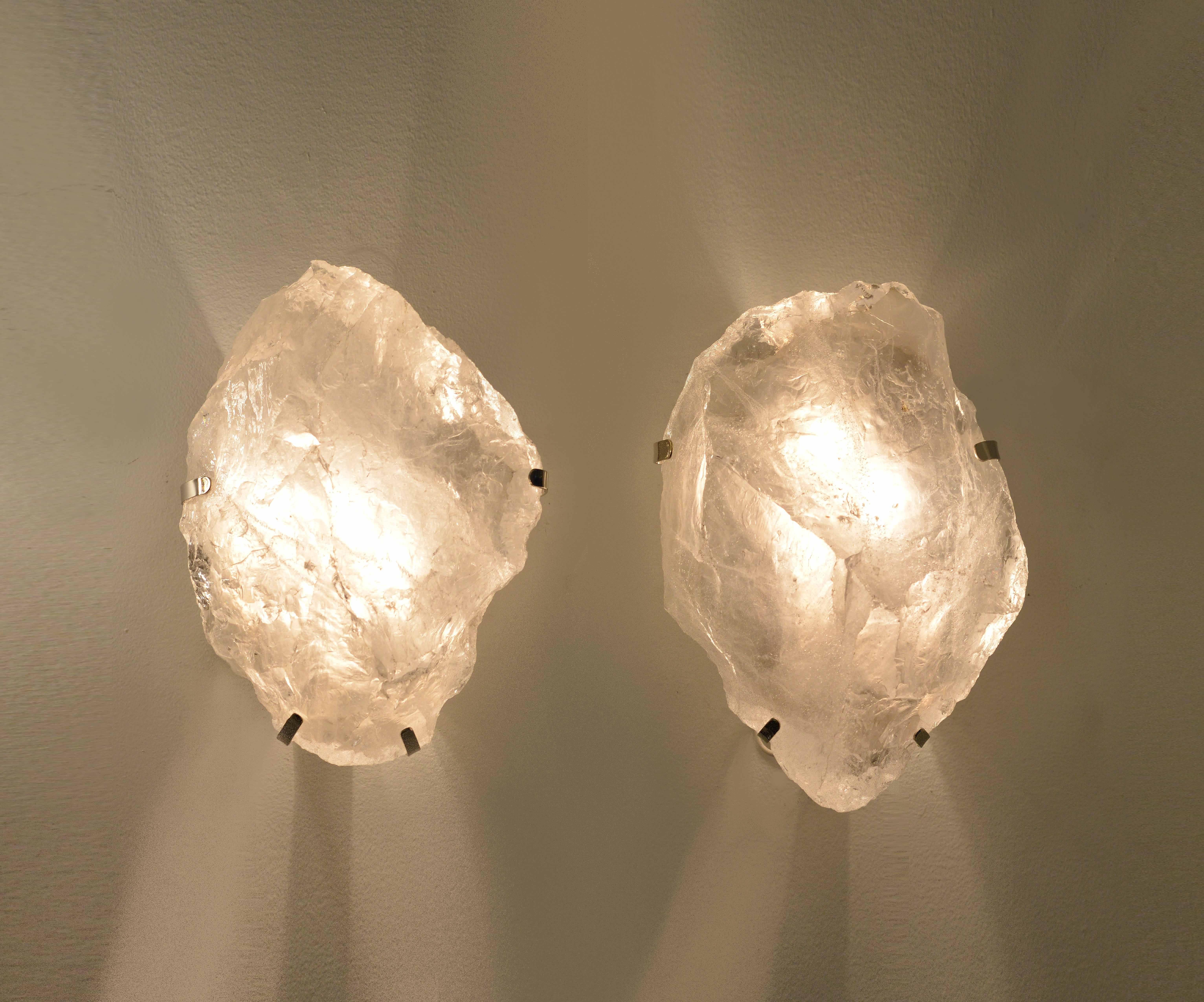 Pair of natural rock crystal quartz wall sconces with nickel plating, mounted. 

Wall sconces installed with two sockets, 60 watt each socket, total of 120 watt maximum.
 
