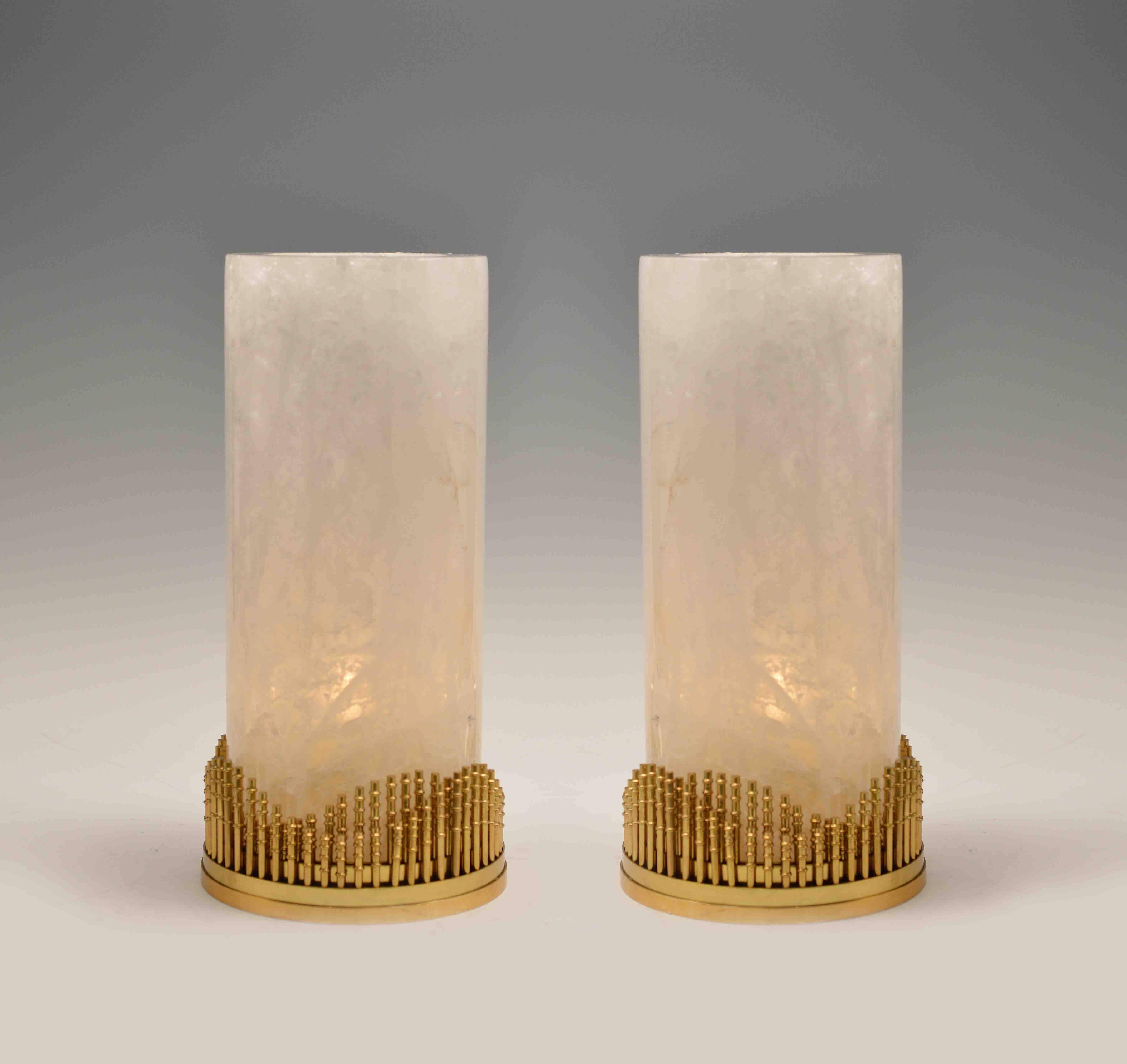 A pair of fine carved rock crystal quartz lanterns with matte brass bases and decorations, created by Phoenix Gallery, NYC.
