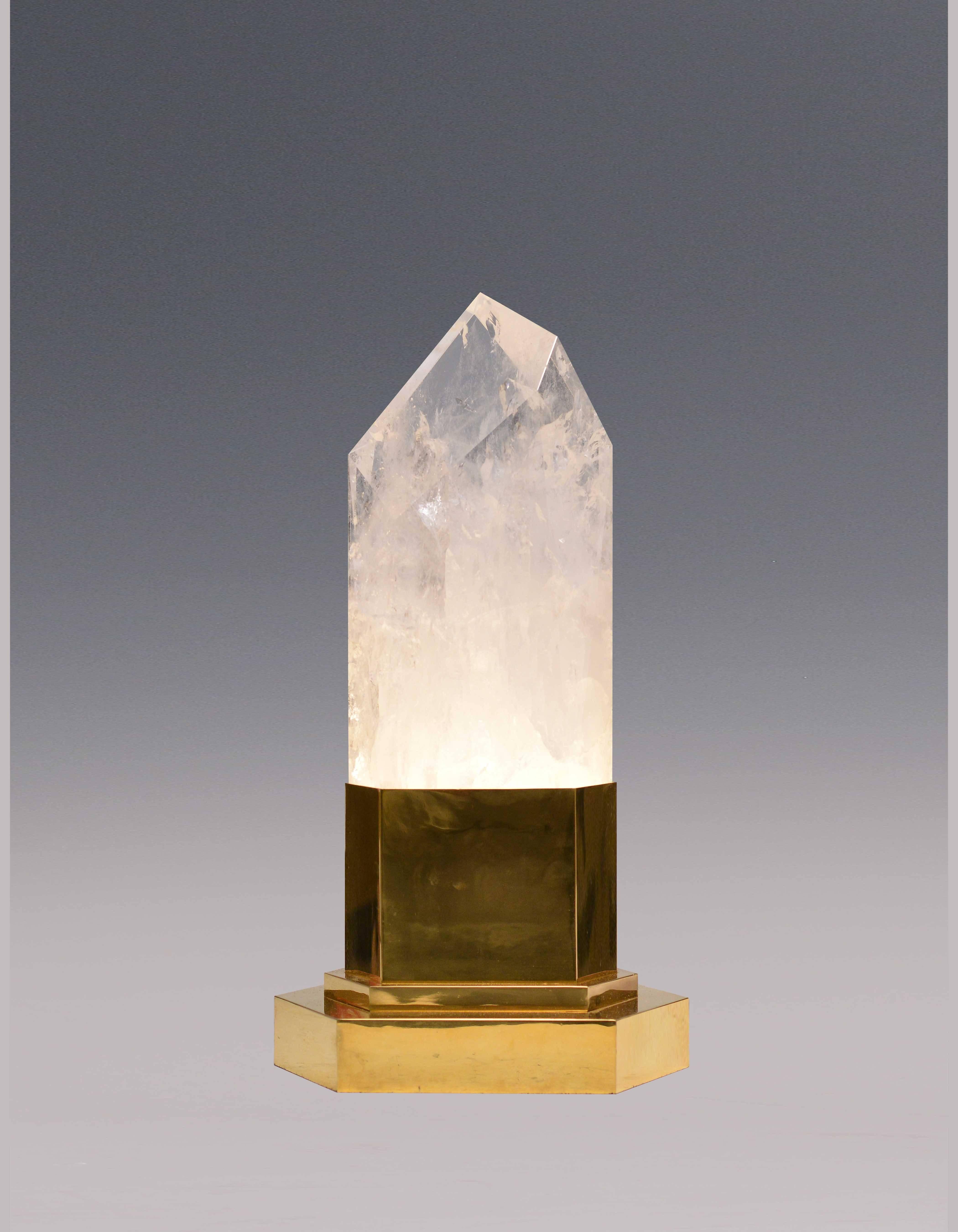 A fine carved rock crystal quartz obelisk light with tall polish brass base, created by Phoenix Gallery, NYC.
Available in nickel plating and antique brass finish. 
One socket installed with max 60 watt. 
A pair available.