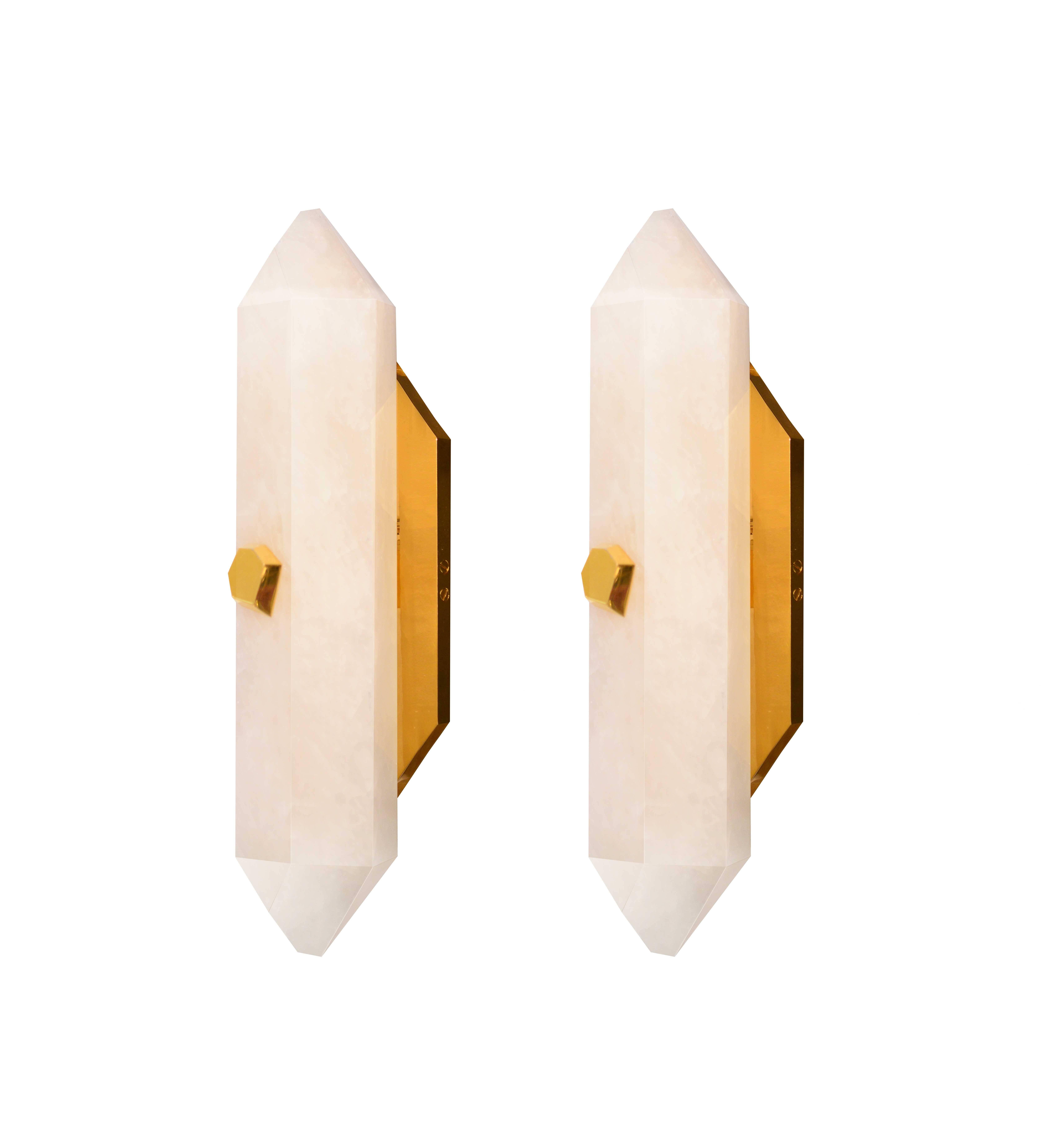 A fine carved diamond form rock crystal quartz wall sconces with diamond form polish brass bolt, created by Phoenix Gallery, NYC.
Multiple lot available.
Custom measurement and finish available. 
Each sconces installed two sockets, and will