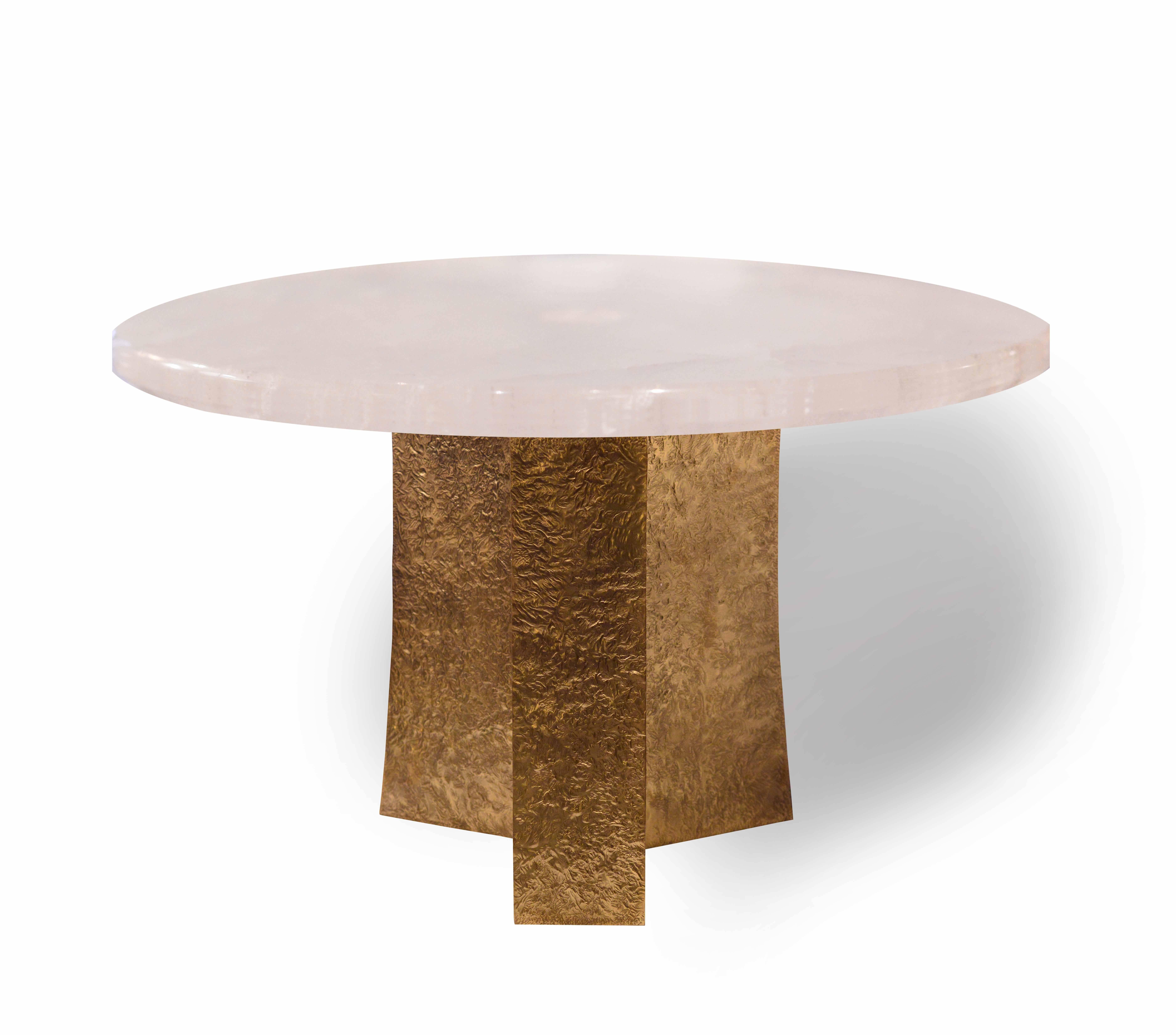 A rock crystal quartz tabletop with hammered polish brass finish metal base, created by Phoenix Gallery. 

Available in custom measurement and finish.
  