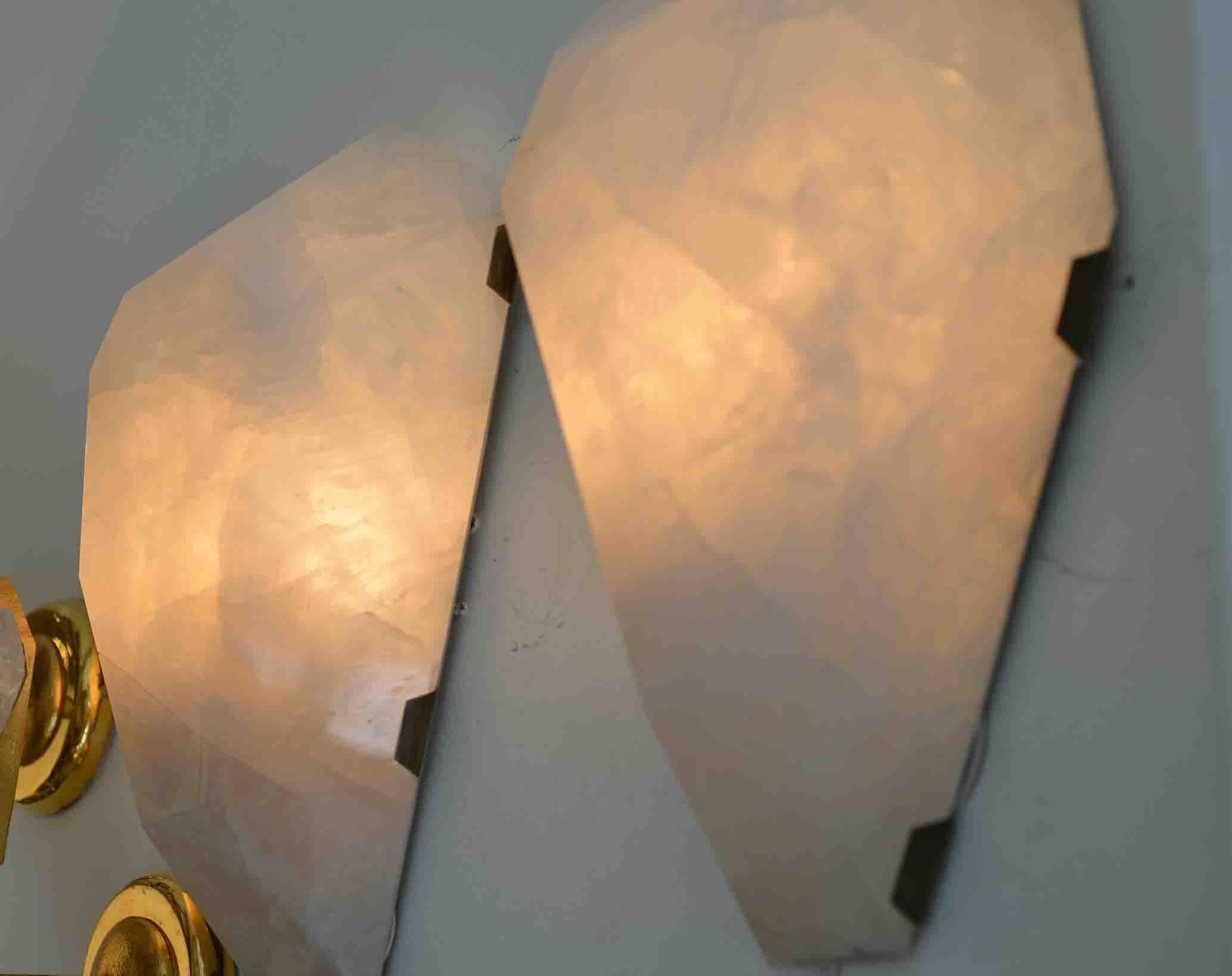Pair of fine carved diamond form rock crystal quartz sconces with antique brass mount, created by Phoenix Gallery, NYC.
Each sconce has two sockets with candle light bulbs max of 80W.
Custom measurement and finish available.
Measures: 15 in/H x 11