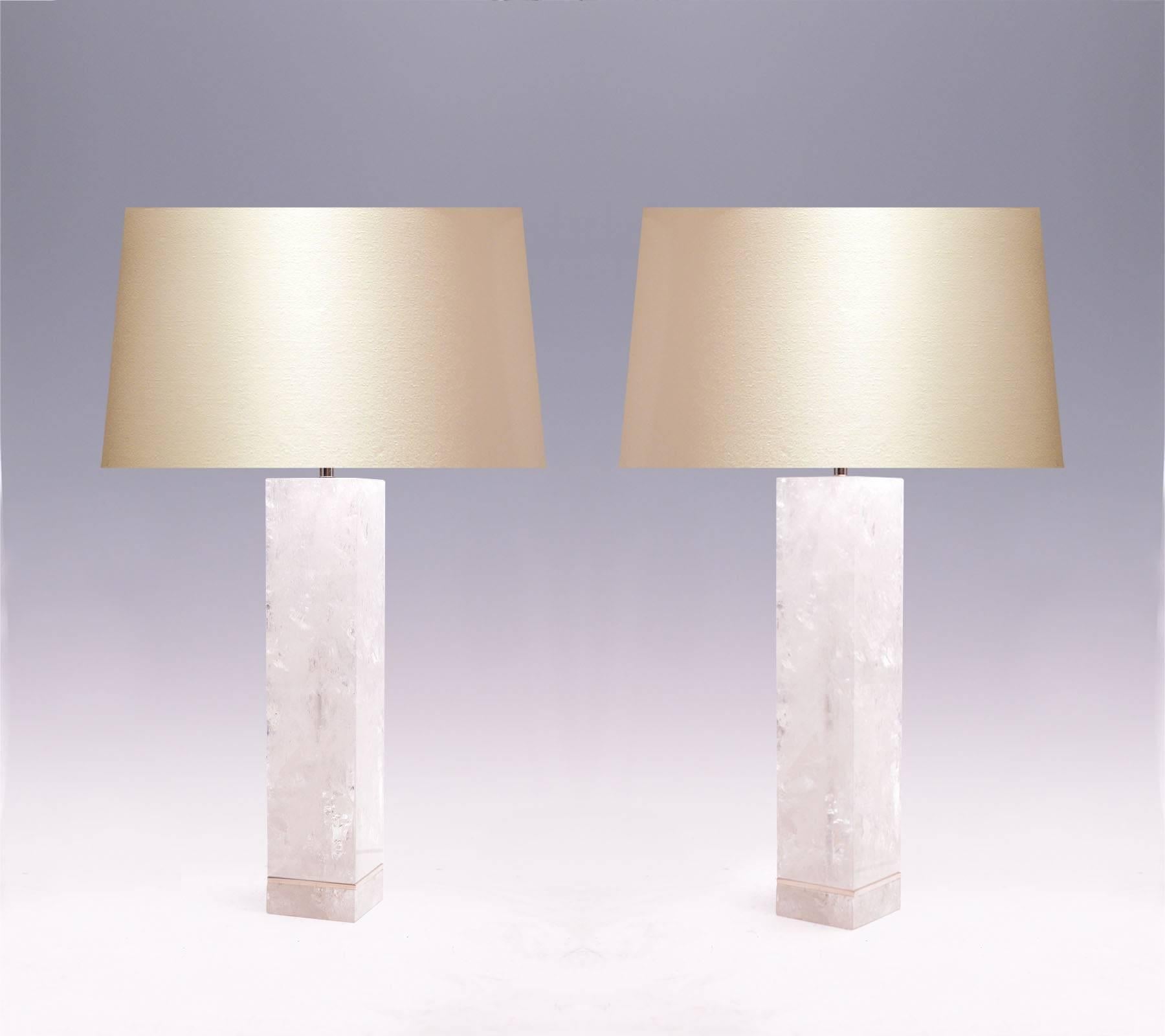 A pair of large square column-form rock crystal quartz lamps with polished brass insert in the lower part, created by Phoenix Gallery, NYC.
Measures to the rock crystal: 18.25