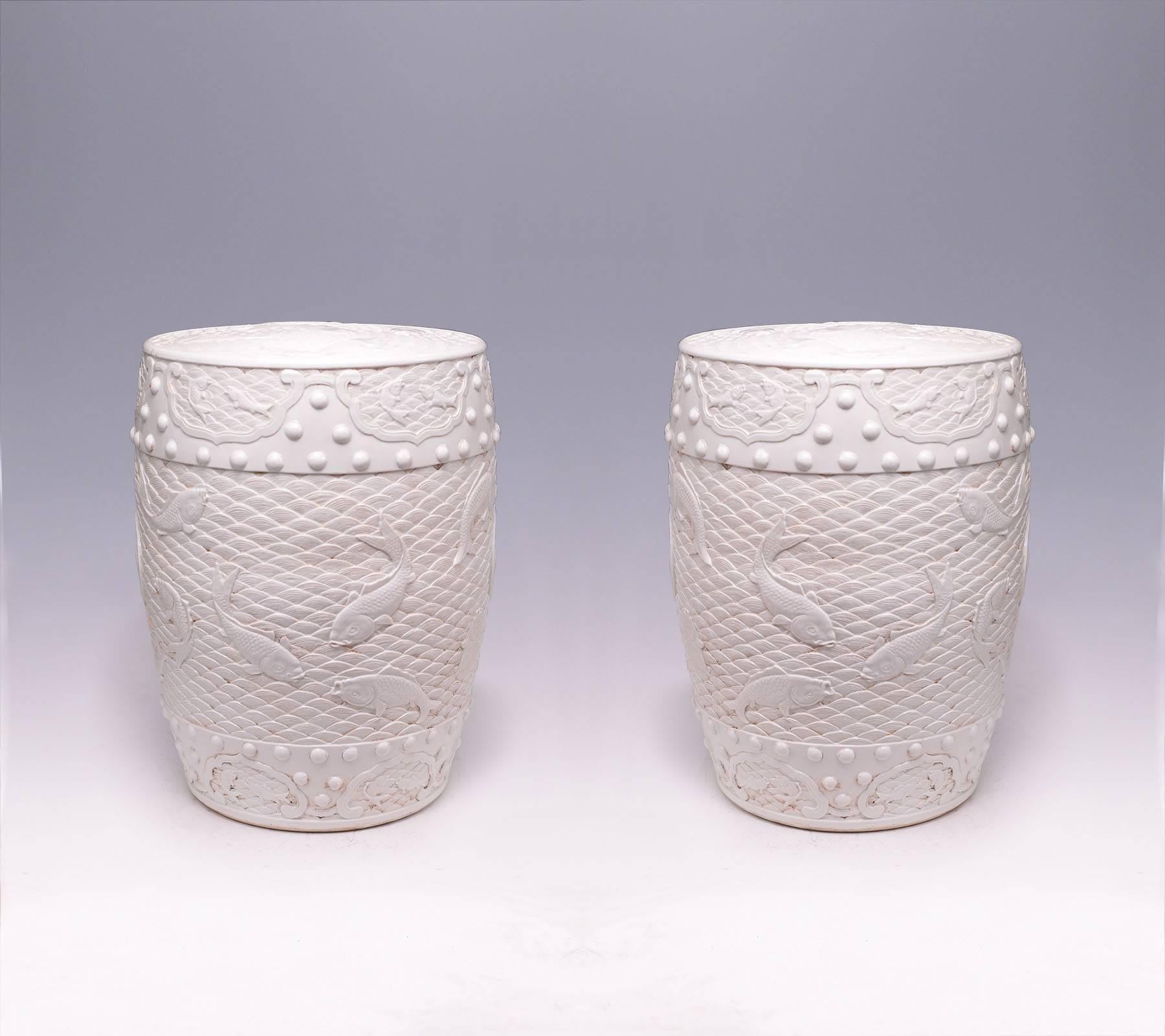 Pair of fine carved Blanc-de-chine porcelain stools with swimming fish decoration.