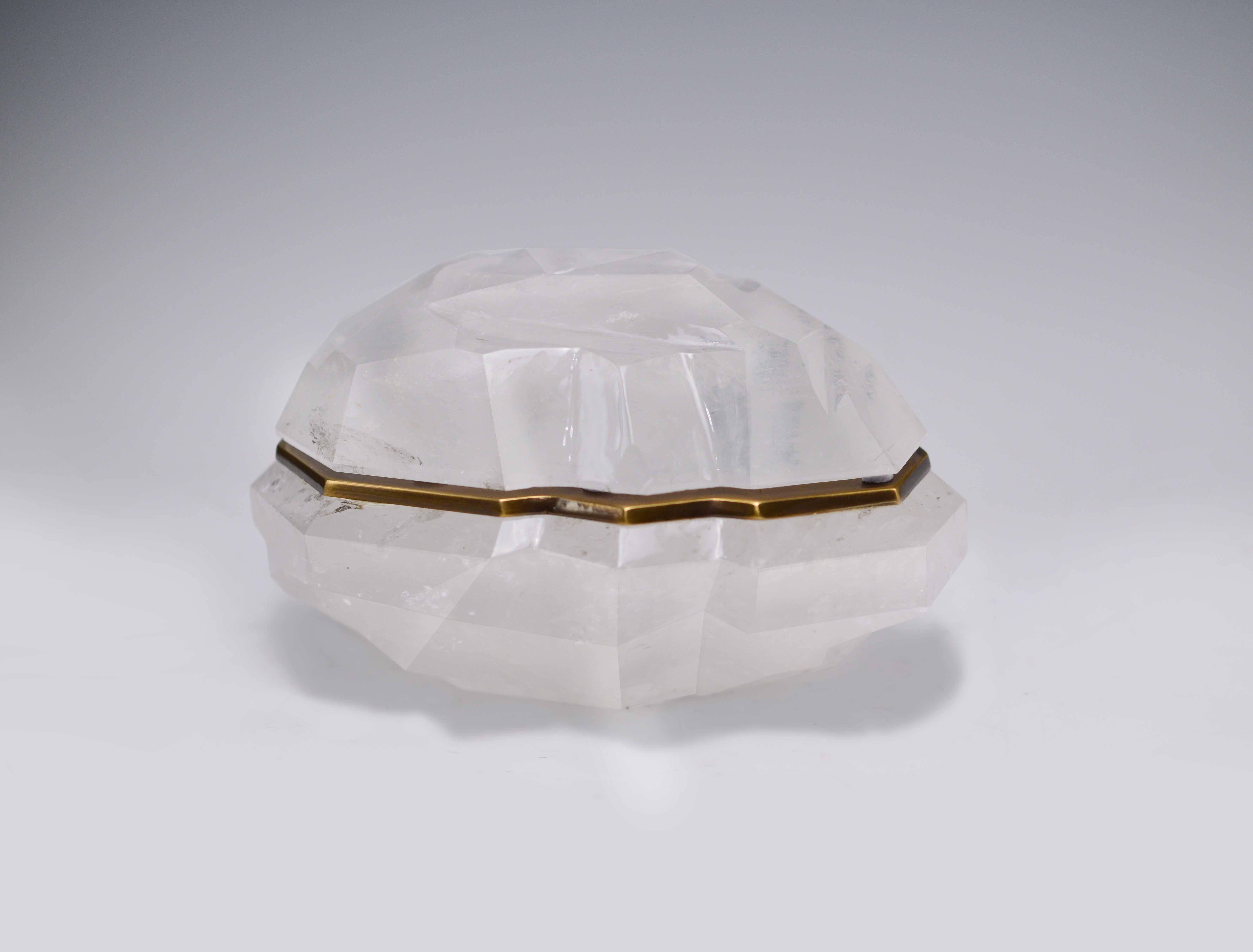 A fine carved abstract form rock crystal box with cover and antique brass decoration, created by Phoenix Gallery.
