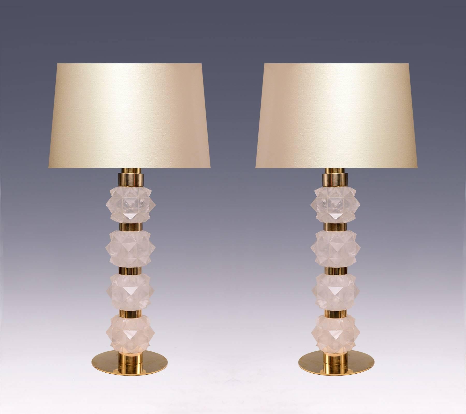 A pair of fine carved rock candy form rock crystal quartz lamps with polished brass decorations, created by Phoenix gallery.
Lampshade not included.
