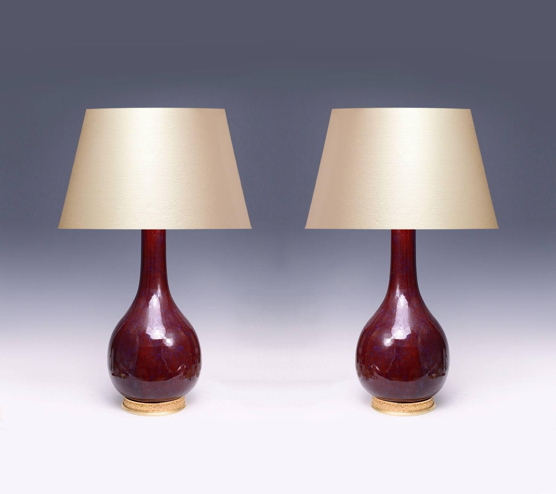 Pair of red-glazed porcelain lamps with gilt bronze bases
To the top of the porcelain: 22" H
(Lampshade not included).