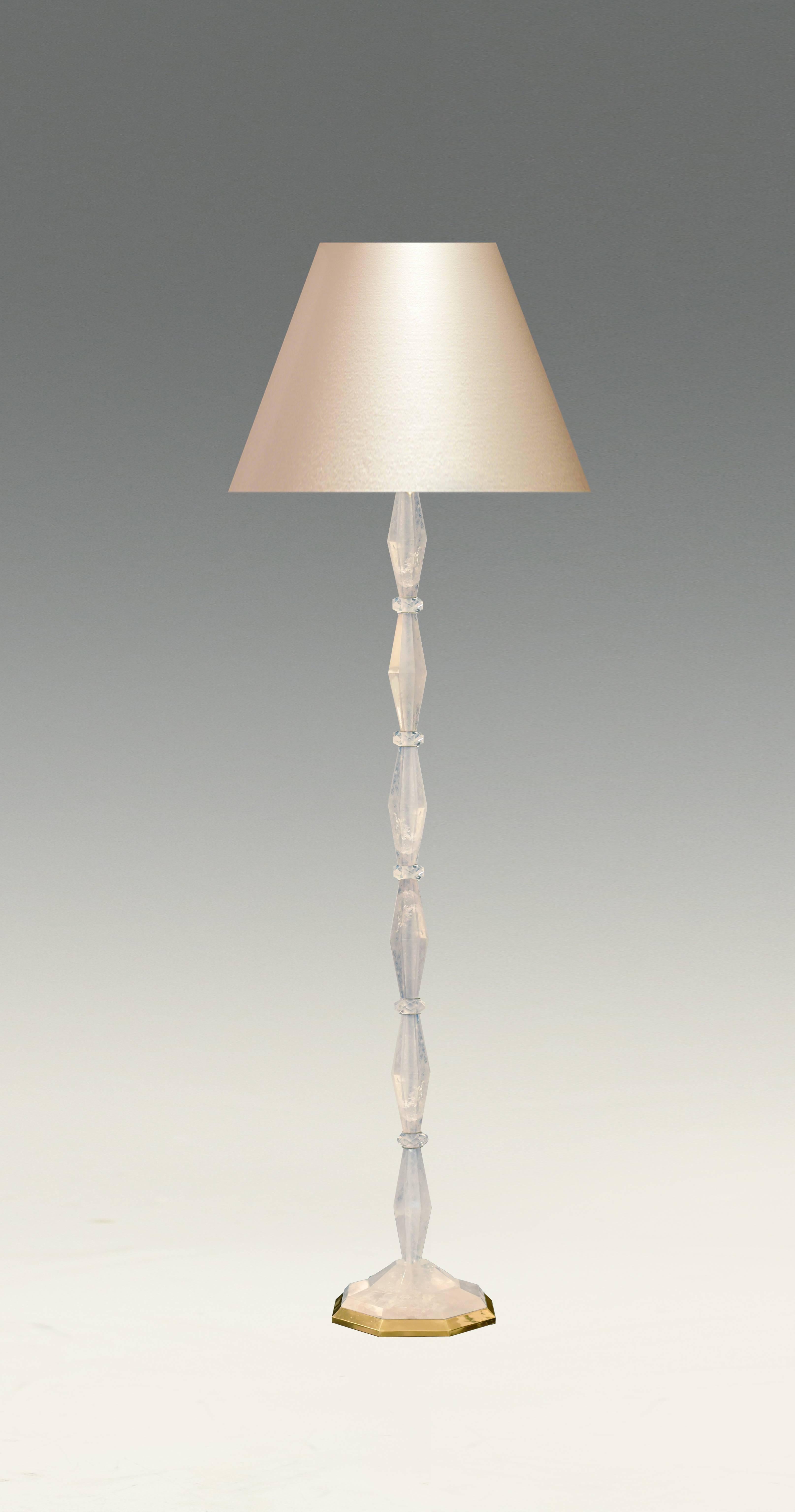 A carved diamond form rock crystal quartz floor lamp with gilt base, created by Phoenix Gallery, NYC.
To the rock crystal: 56 inch H.
(Lampshade not included)
