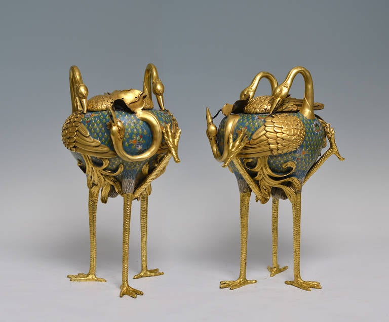 The cloisonne censer formed by hollow shared body of three cranes standing on long legs.
