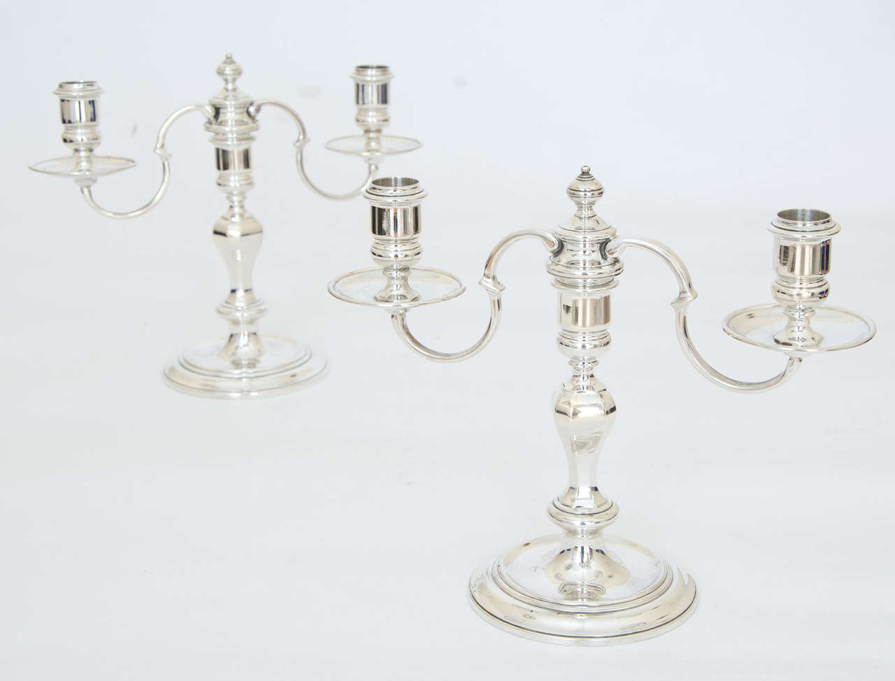A pair of English sterling silver candelabra made in London, 1953 and along with the usual hallmarks there is also the Coronation hallmark of Queen Elizabeth II.
The two-light branches can be removed so that they can be used as a pair of