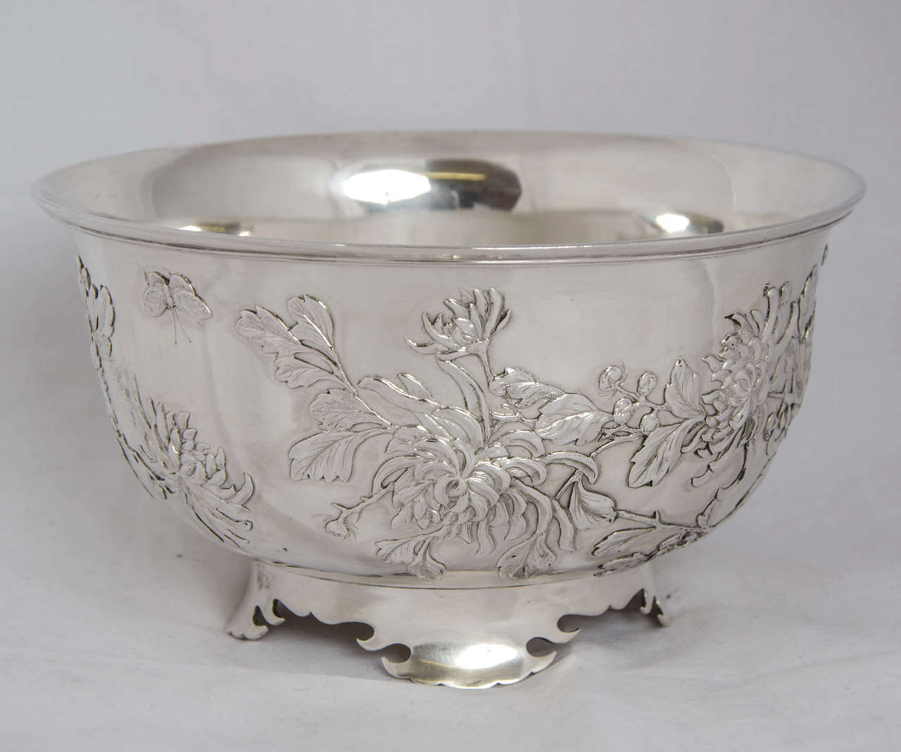 A Chinese export silver bowl made by Wang Hing, circa 1890. The bowl has applied chrysanthemum decoration as well as two butterflies, one to either side.
The diameter is 19 cm and the weight is 641 gm.
