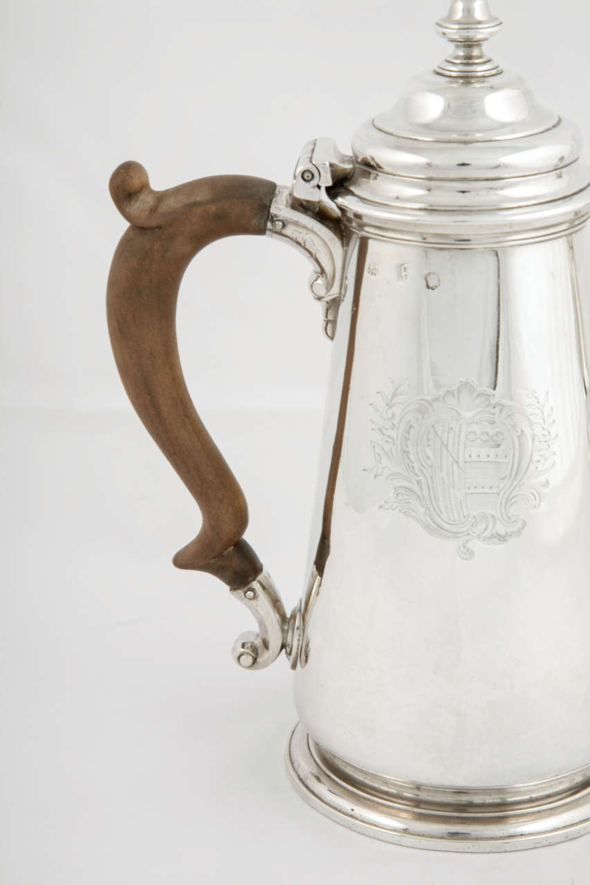 A George II coffee pot made by George Wickes in London, 1741.
This lovely example by one of the most important silversmiths of the mid-18h century, measure: stands 22.5cms high and weighs 756 gms including the wood handle.
The coffee pot has a