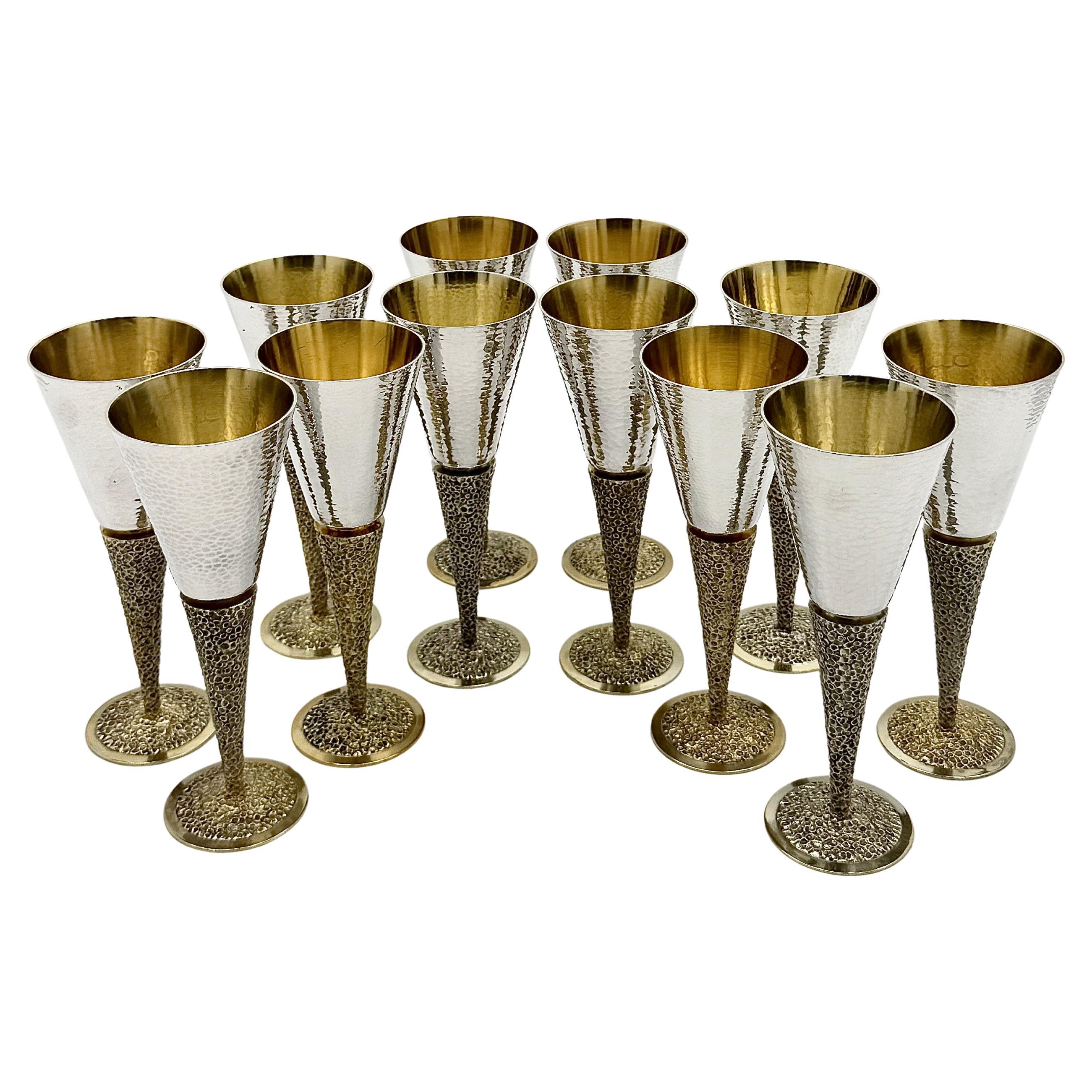 Set of Twelve Silver Goblets, made by Stuart Devlin and hallmarked London 1968. 
Each goblet features a hammered silver bowl above a textured gilt stem and foot, reflecting Devlin’s distinctive combination of modern design and traditional