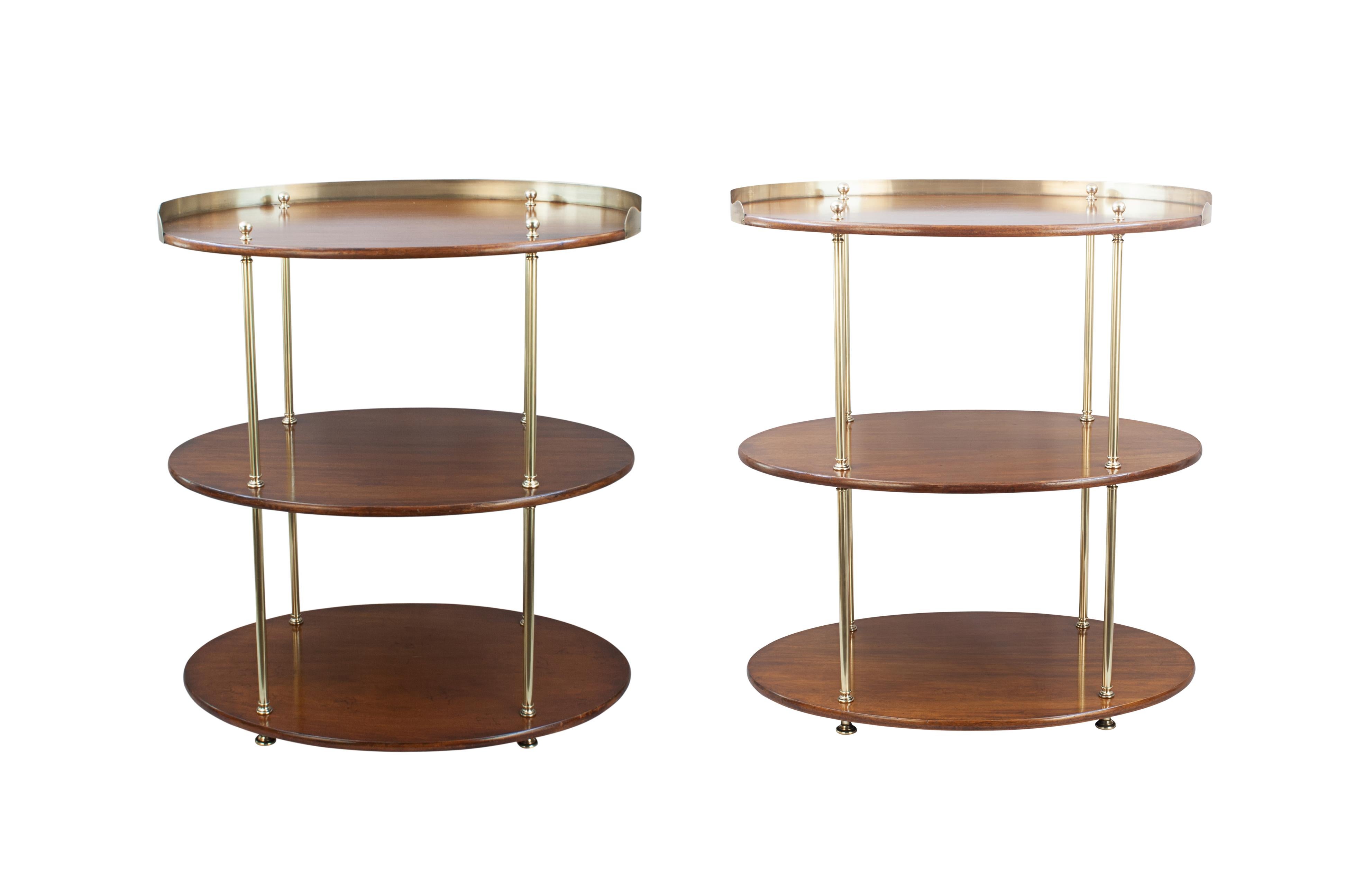 Vintage Pair Of Oval Campaign Three Tier Buffet, What Not Stands.
A great pair of oval mahogany and brass campaign étagères. The three tier stands with three shelves are separated by brass columns terminating in heavy shaped round feet and topped