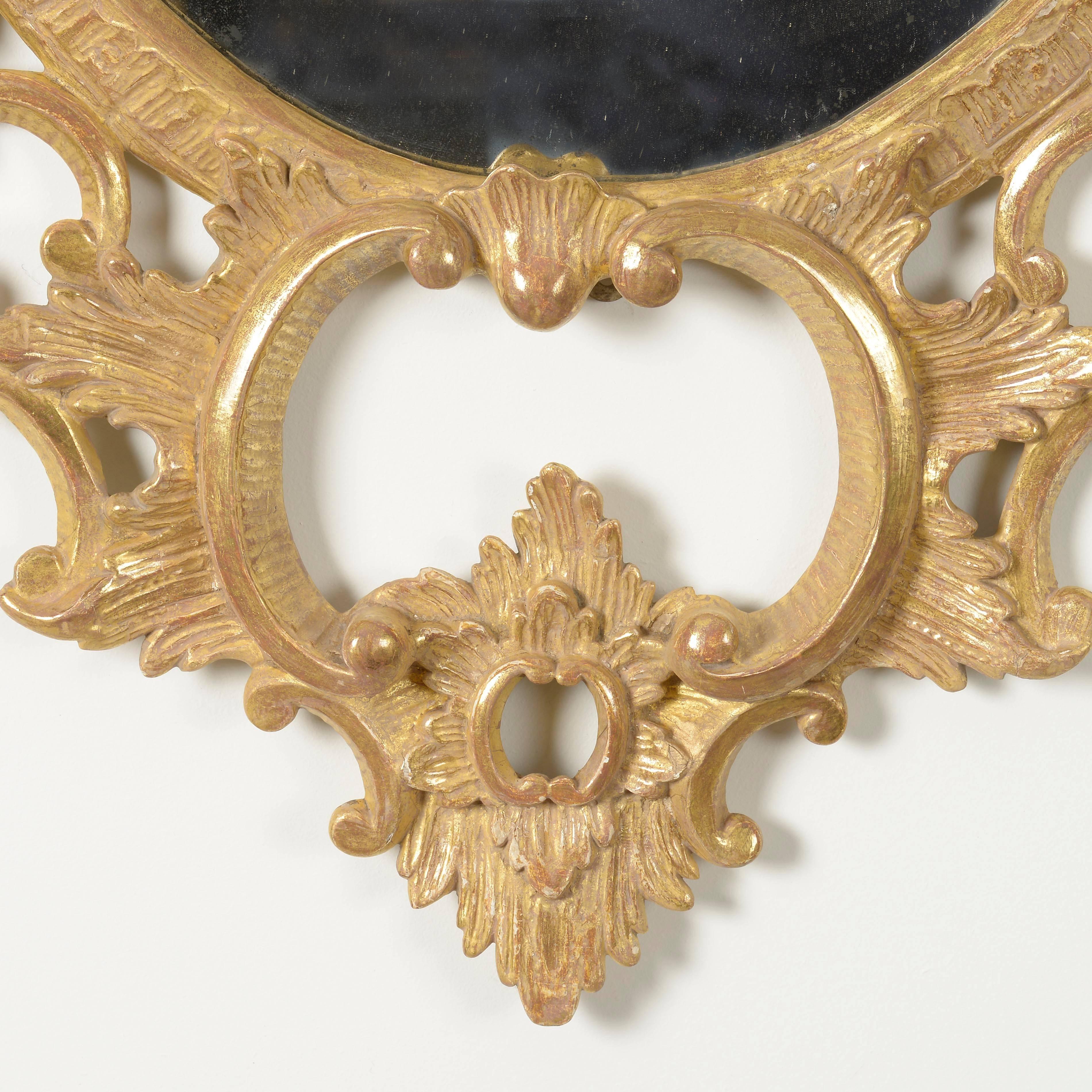 English Pair of George III Carved Giltwood Oval Mirrors For Sale