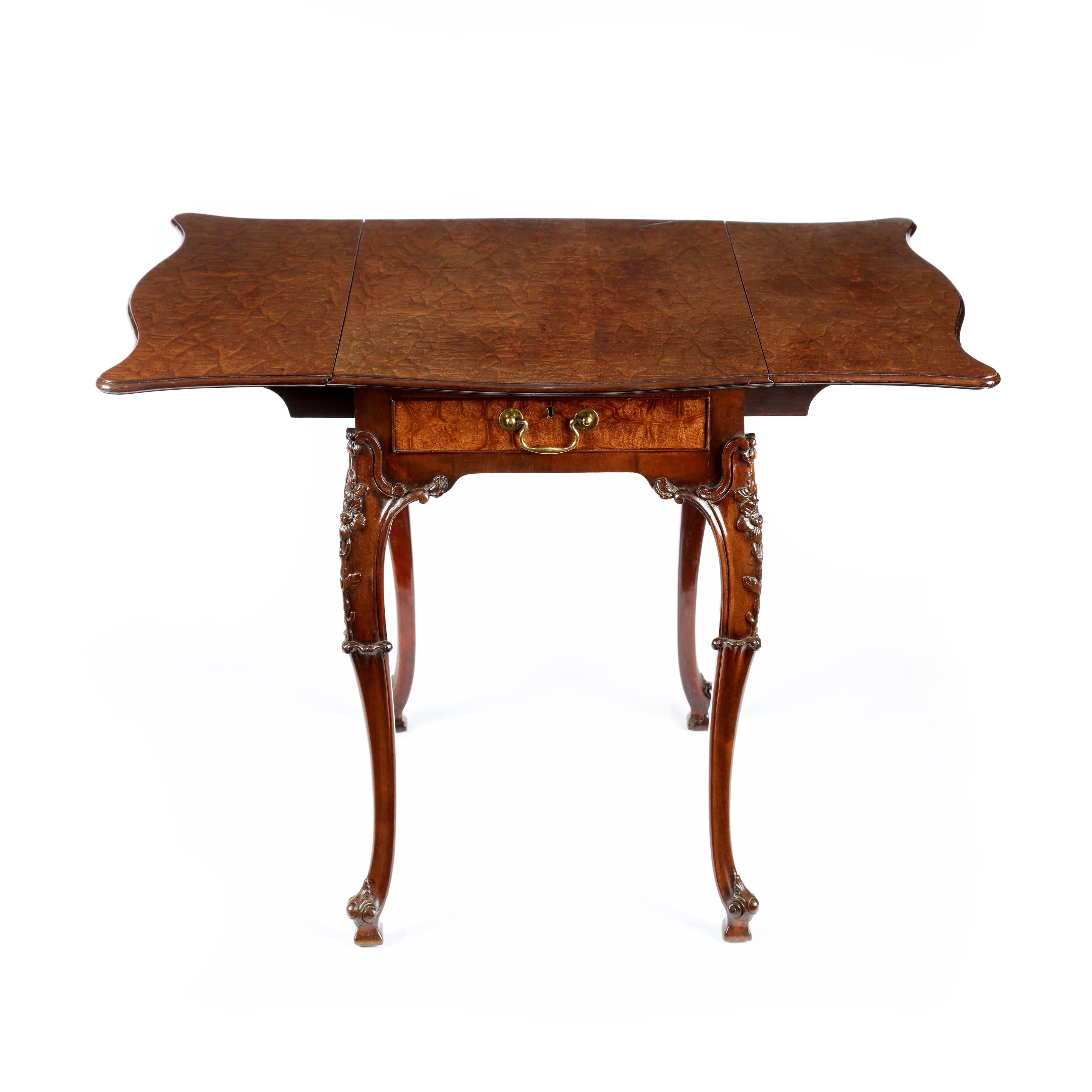 Description: A rare George III “crocodile” and carved mahogany butterfly top pembroke table, attributed to Thomas Chippendale. The wonderfully figured “crocodile” or “fustic” mahogany top of serpentine shape to all for sides forming a “butterfly”
