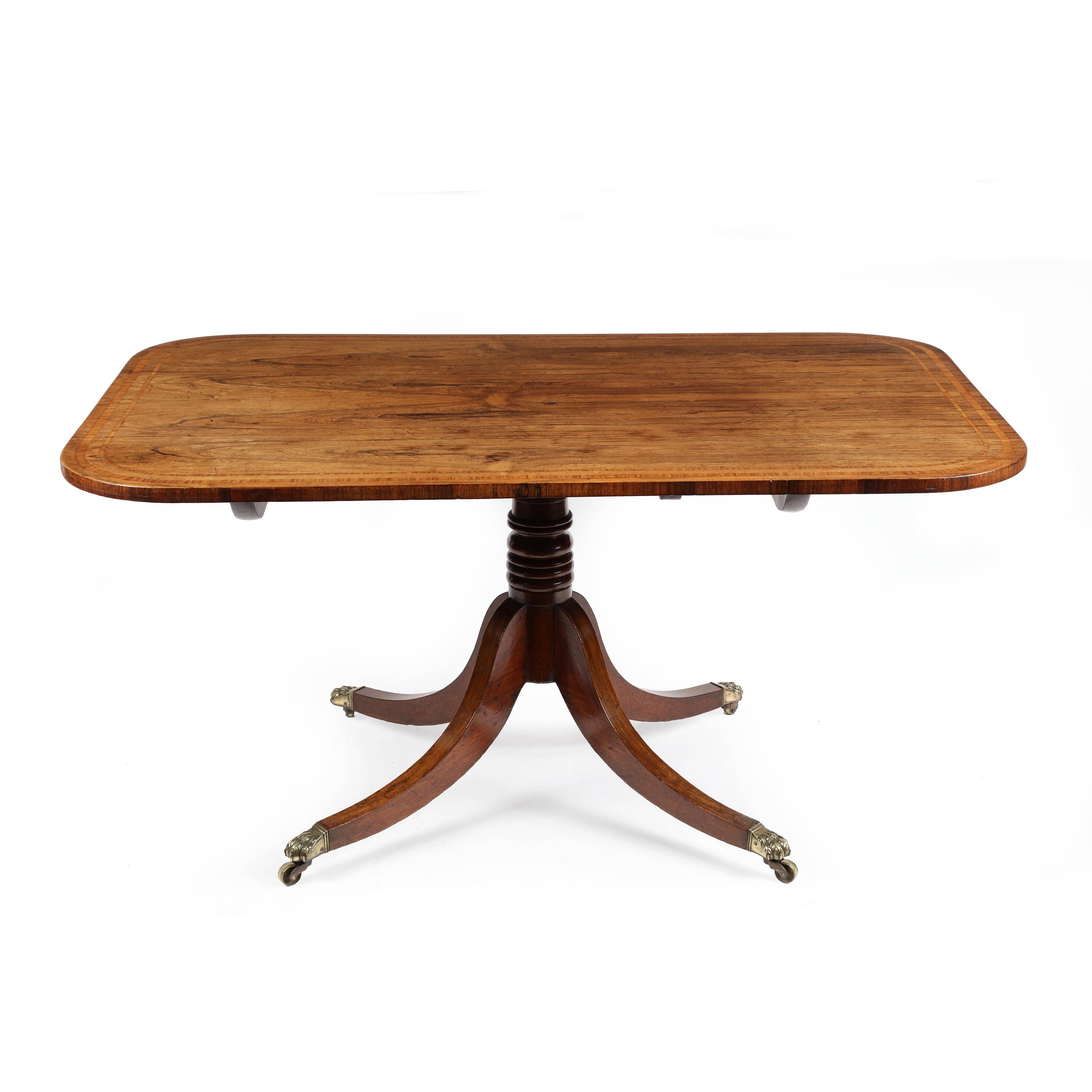 A fine George III Sheraton period rosewood and satinwood banded breakfast table. The rectangular top with rounded corners, laid with extremely well figured rosewood veneers onto a mahogany base and retaining excellent original surface, color and