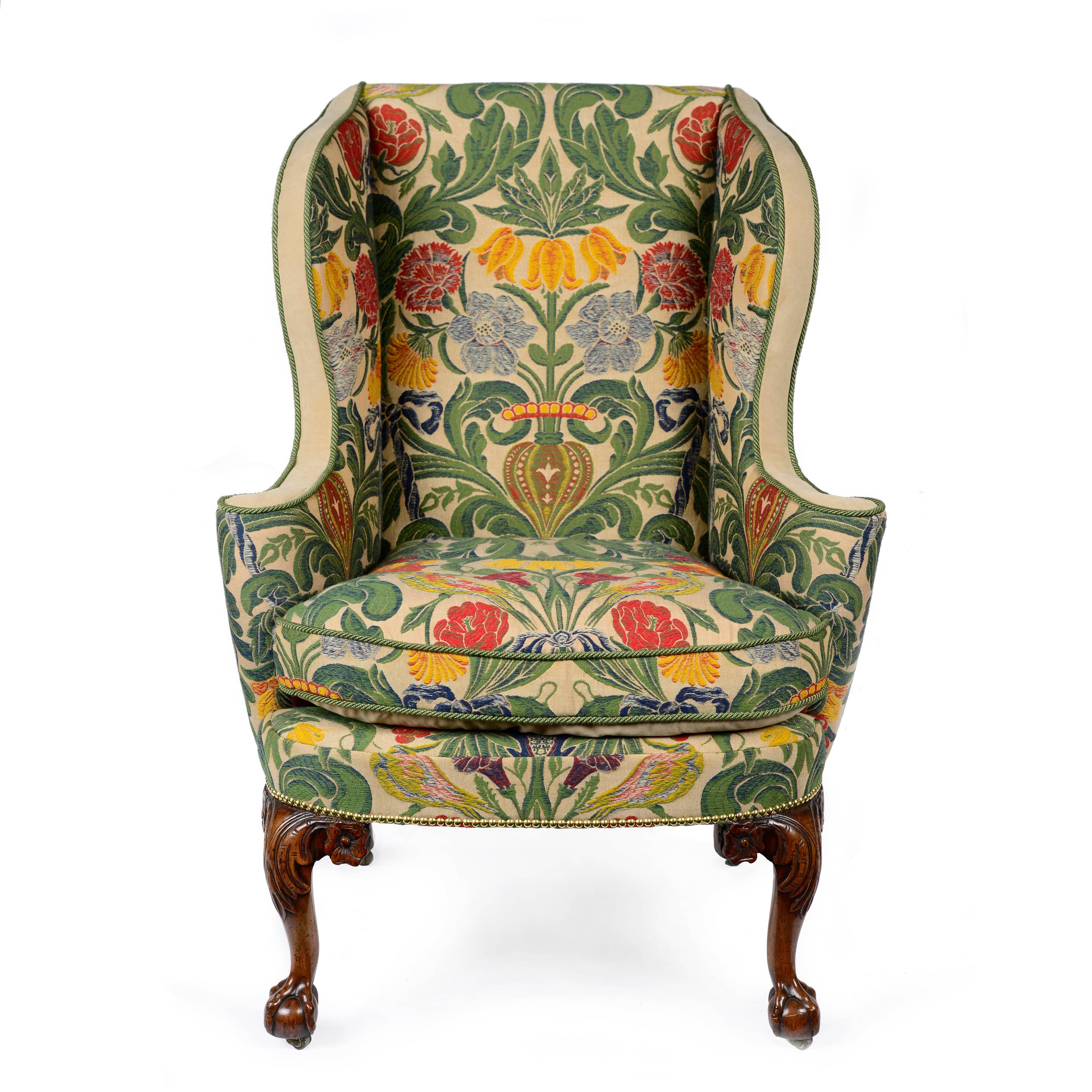 A superb English George II walnut wing back armchair of excellent shape and proportions. The back with straight top flanked by out swept side wings, scrolling outwards to form armrests which terminate in an elegant tightly scrolled column. The seat