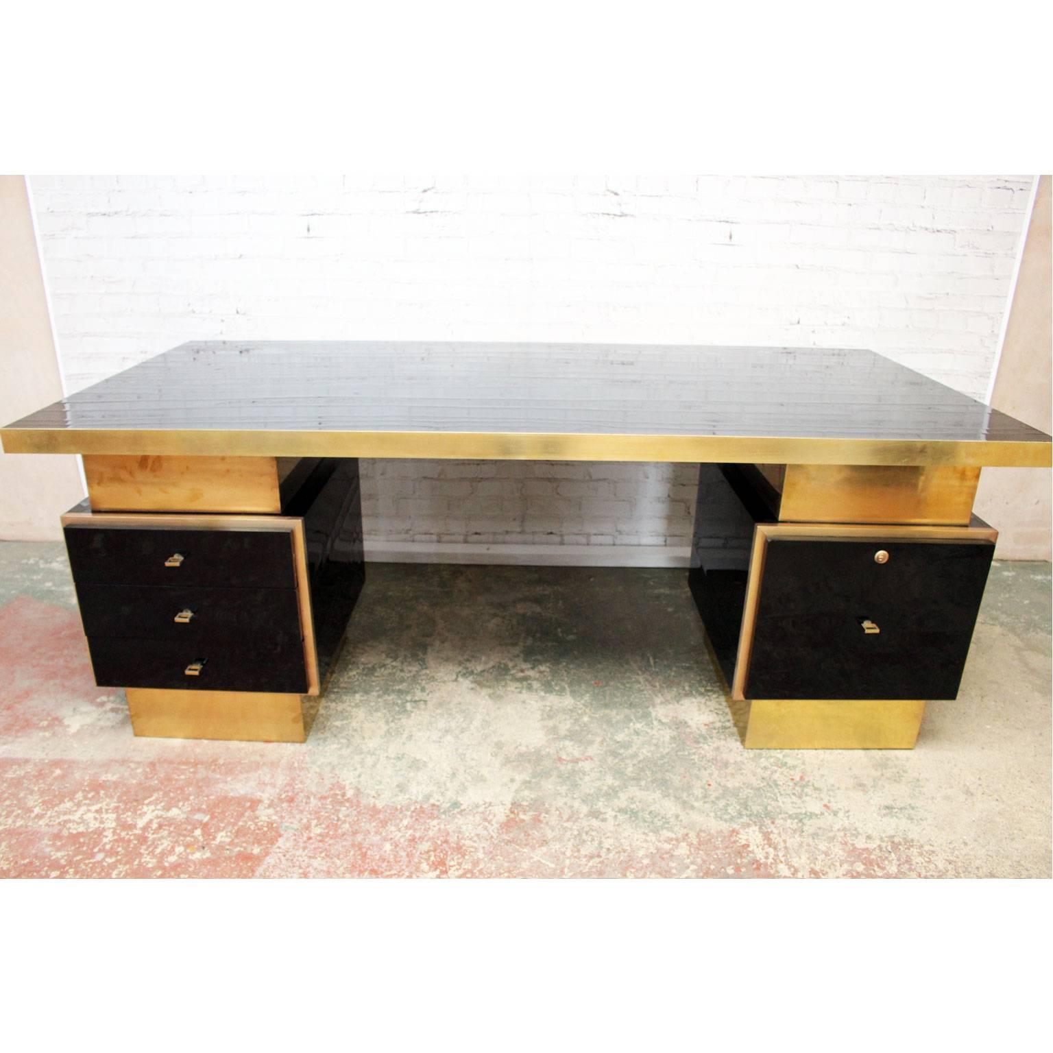 We believe this magnificent desk was designed by a top end French designer as a one-off commission in the 1970s and there are definite hints of the designer Guy Lefevre or Jean Claude Mayer. The scale is extraordinary. The lacquered top and