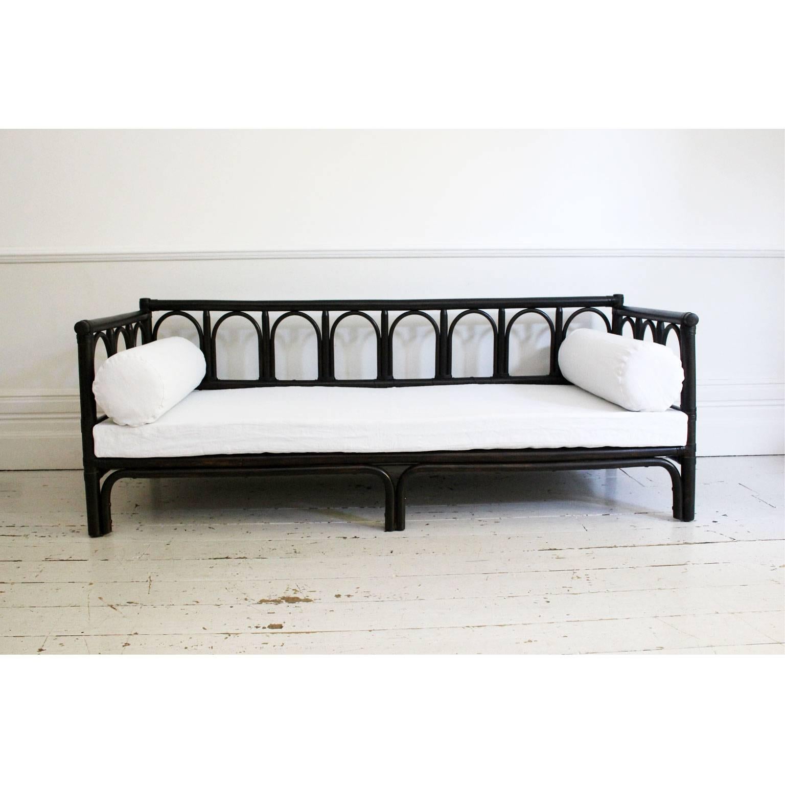 We love this incredibly chic 1970s French bamboo sofa or daybed. The colour is a wonderful, rich, dark brown/black. Charlotte has made cushions and mattress covers for it from antique French linen (which are included in the price). The base is in