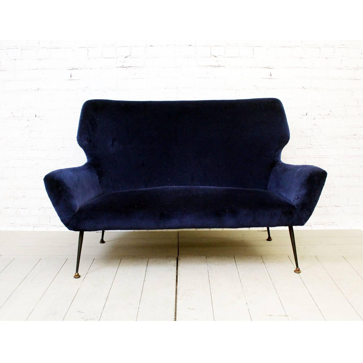 This incredibly stylish two-seat Italian sofa is of the highest quality. We love the design and especially the splayed black legs on brass feet and unusual shape. What is wonderful about this particular sofa is it's compact size. We believe this