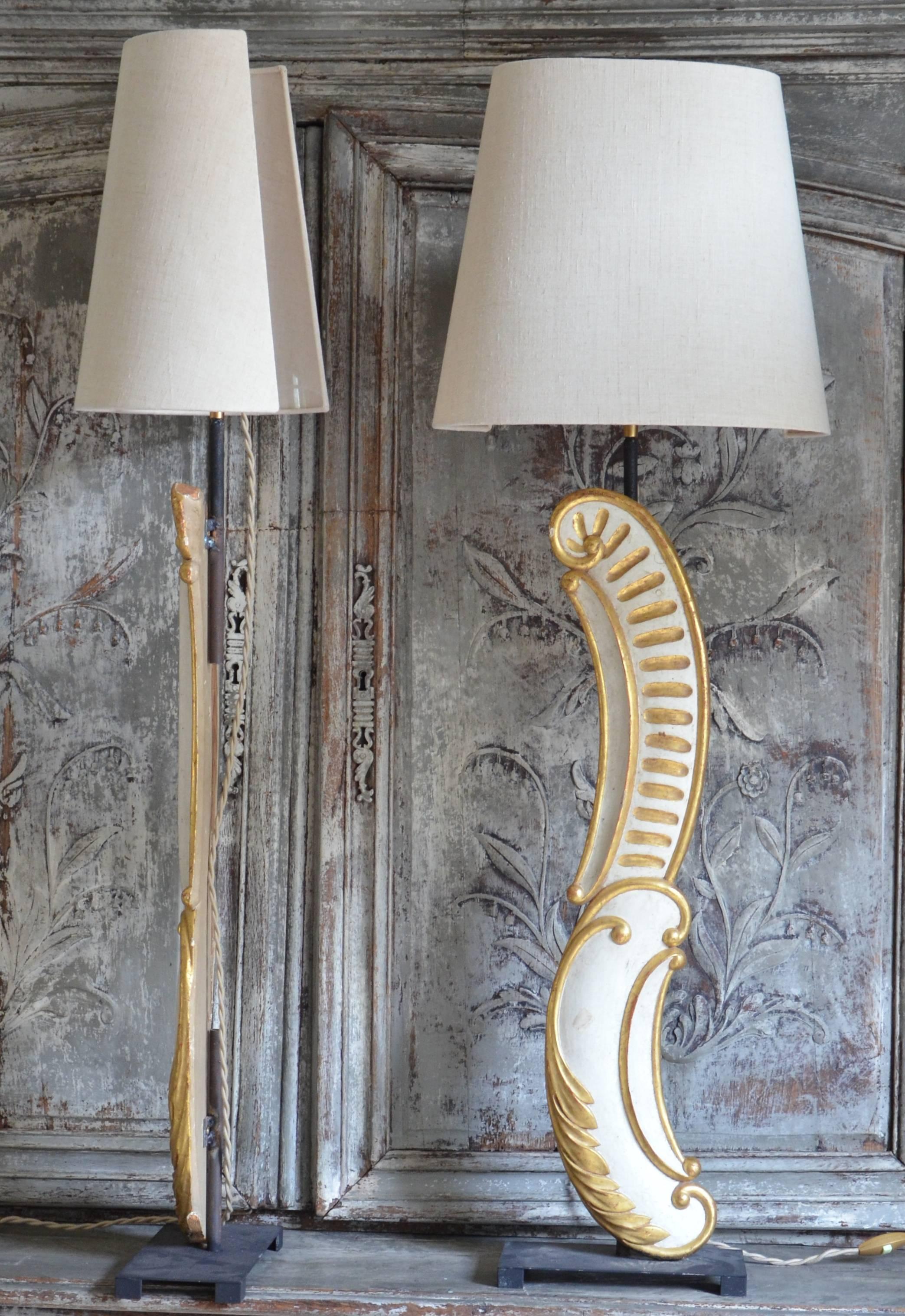 A wonderful, unusual pair of 19th century architectural gold gilded fragments made into the table lamps, mounted on iron base and with custom-made half round linen shades from Paris, France.

Base: 4.75