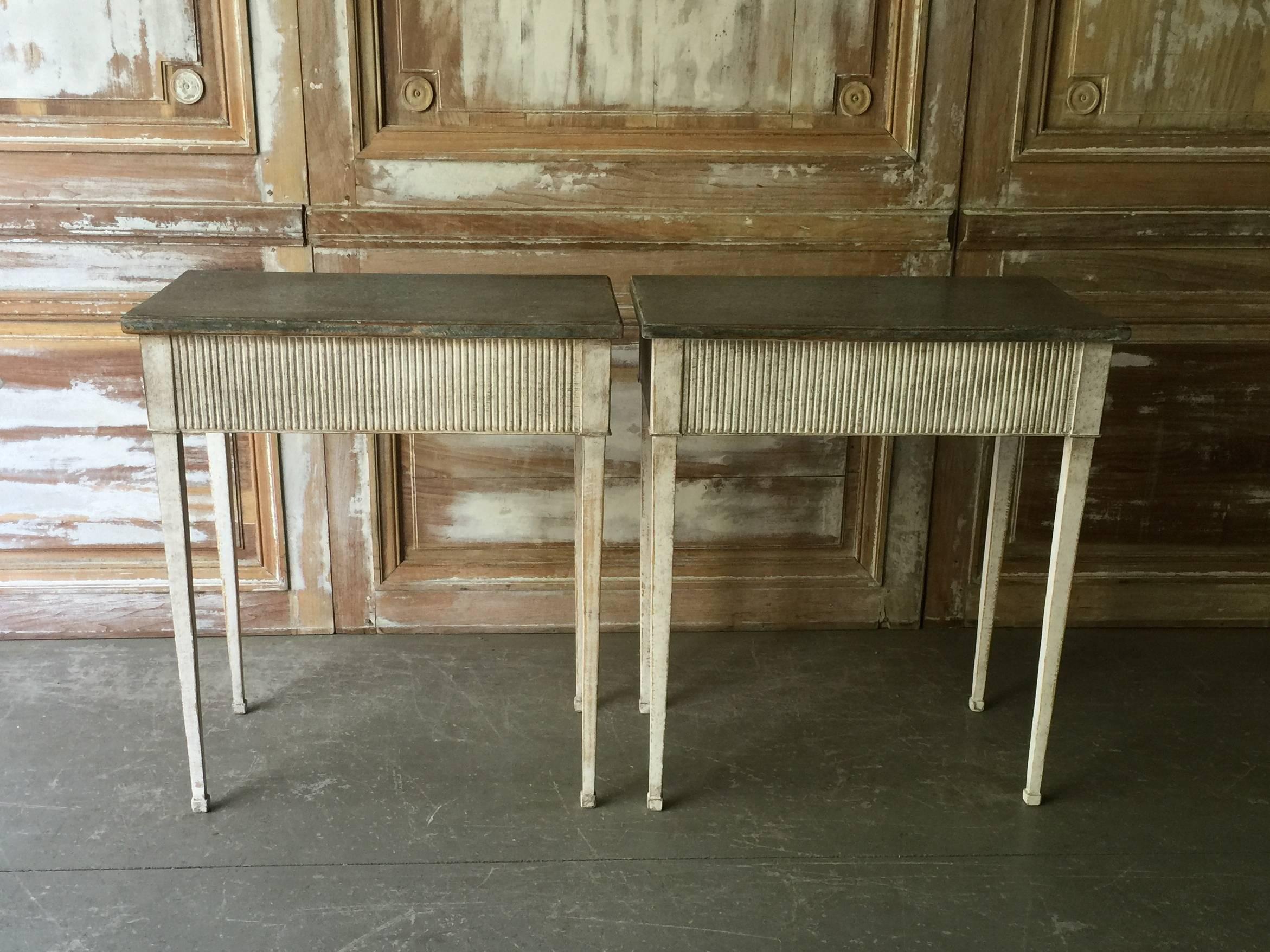 Pair of 19th century Swedish Gustavian Style consoles with simplified reeded apron and tapering legs.
    