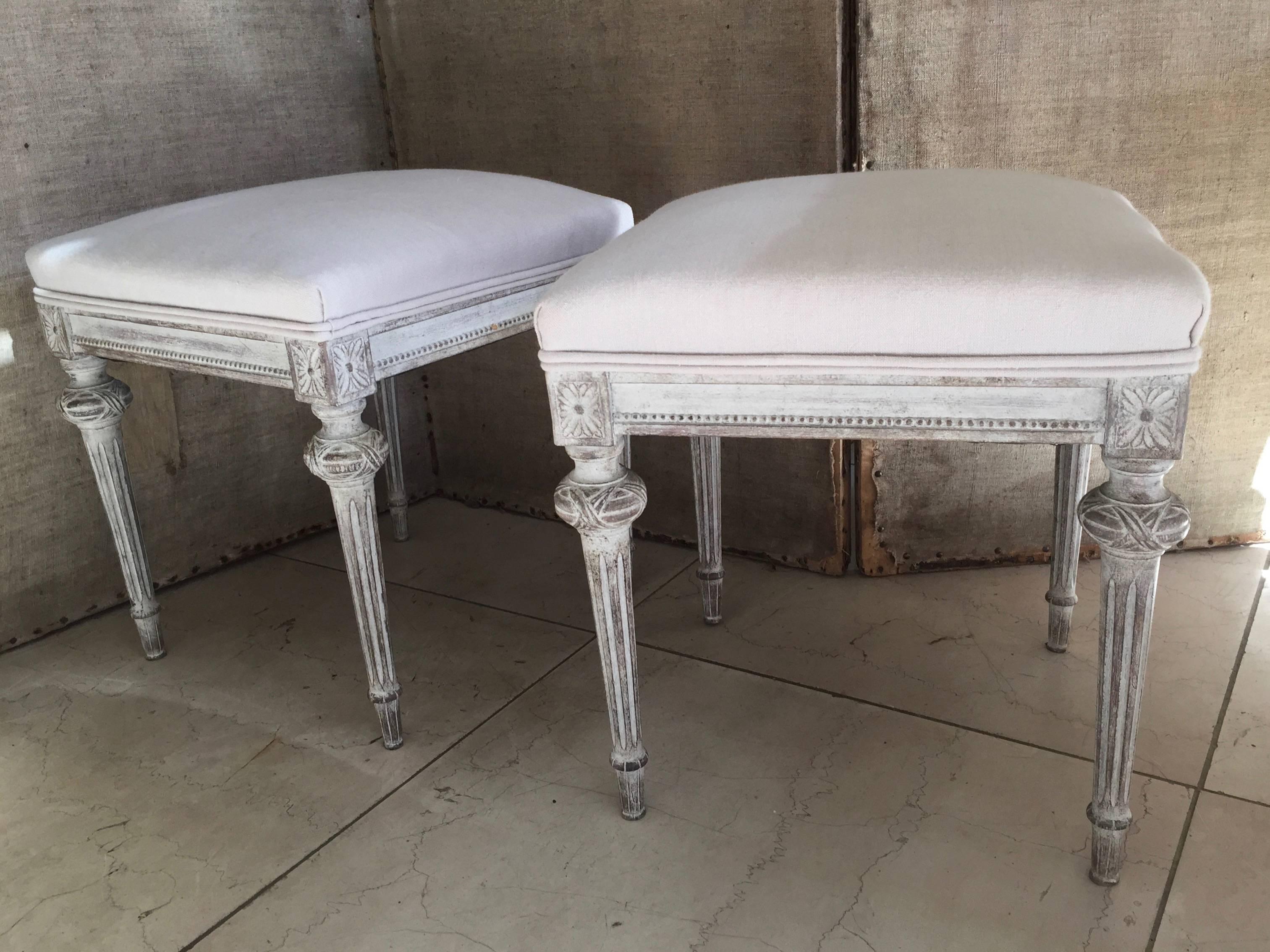 A pair of 19th century Gustavian stools with apron beautifully carved in bead string design and flower rosettes at each corner. Upholstered in linen.
Sweden, circa 1840.
Seat size: 17 W