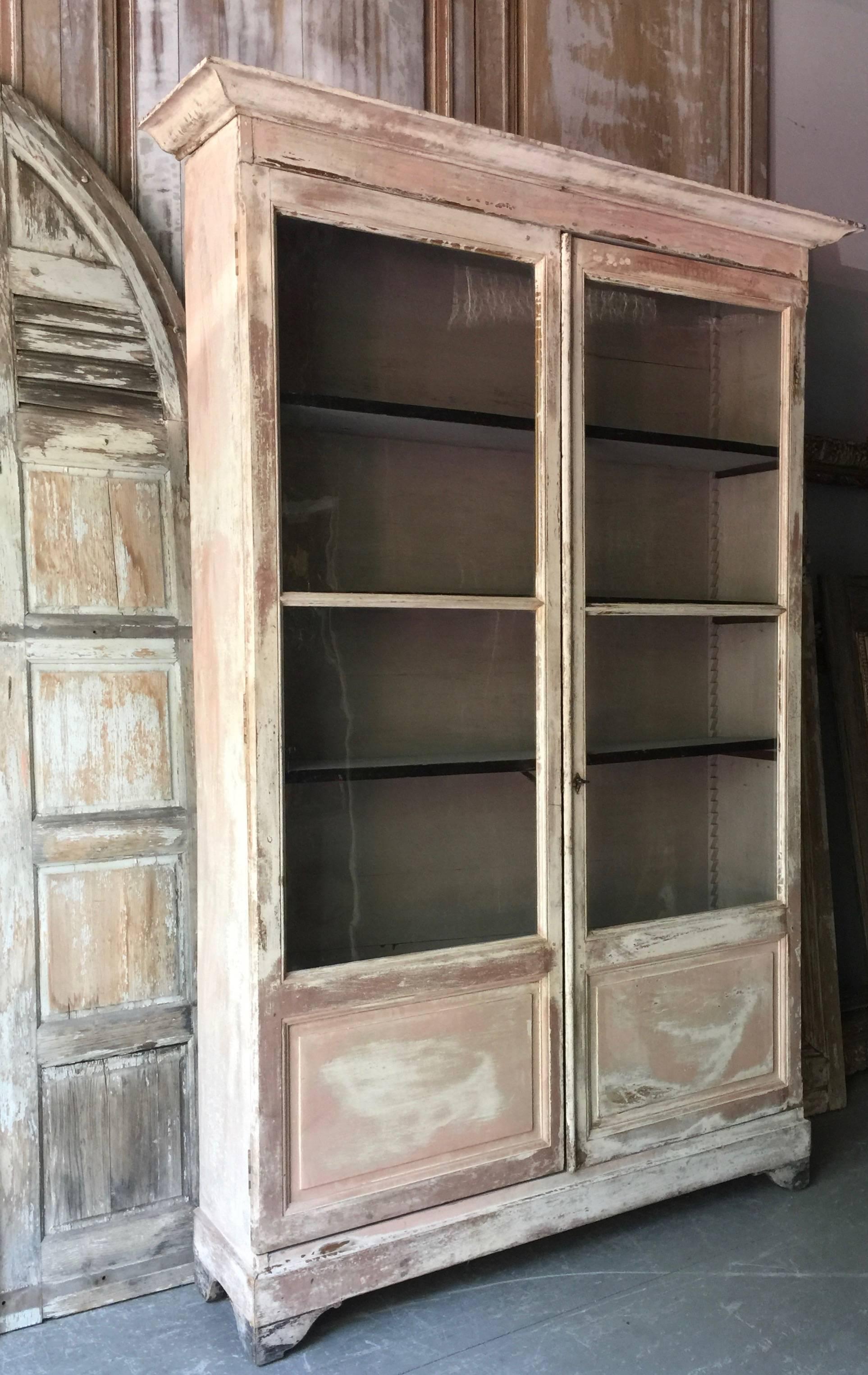 Painted French Bibliothèque with all original; worn paint, all glass panels and hardwares.
France, circa 1880.
Measurement are with cornice and baseboards.
With out cornice: 60.25
