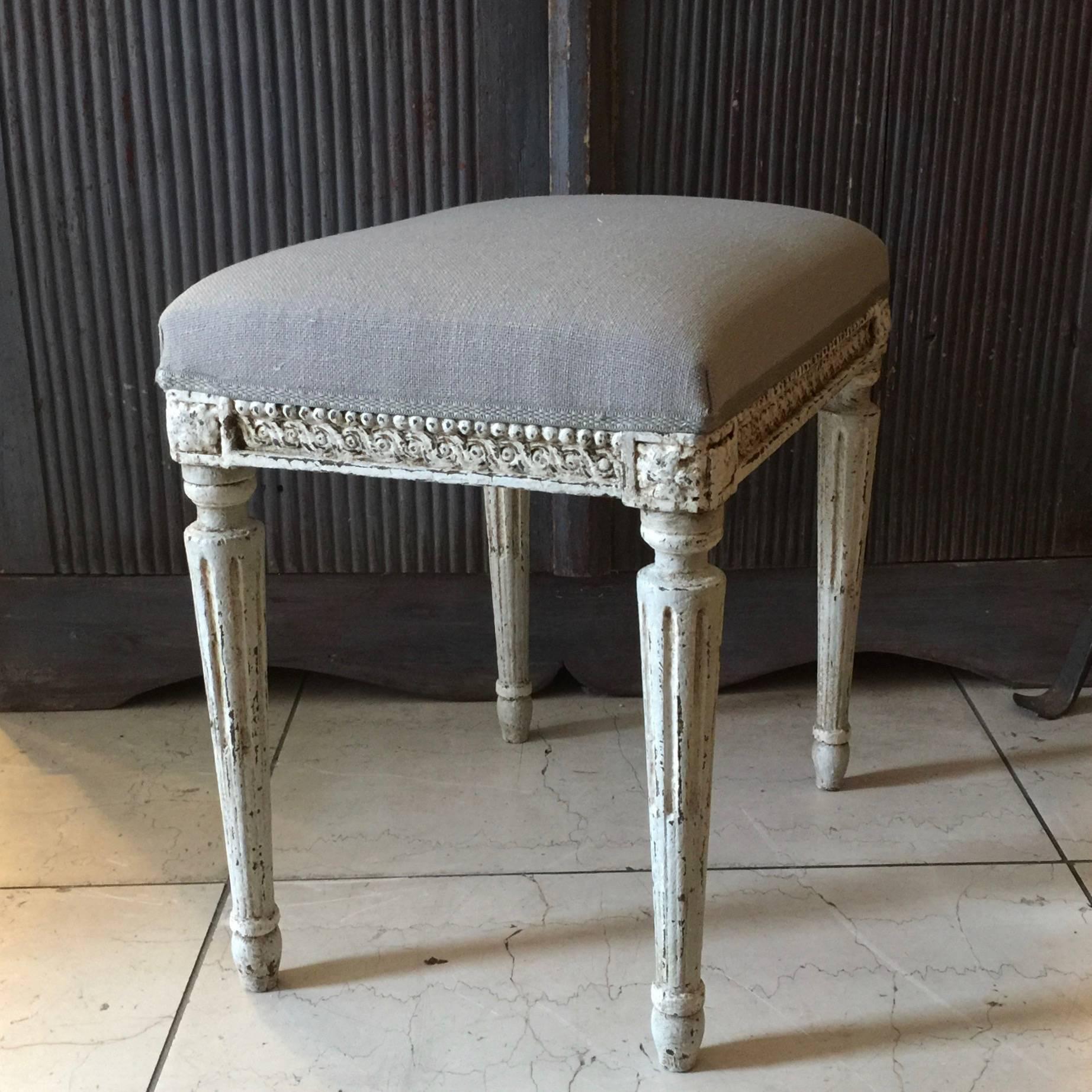 A charming, rectangle in shape, Louis XVI style stool in lovely light blueish grey with legs tapered with flutings and joining dies decorated with a classical daisy motifs. Upholstered in linen fabric,
France, circa 1900.
More than ever, we