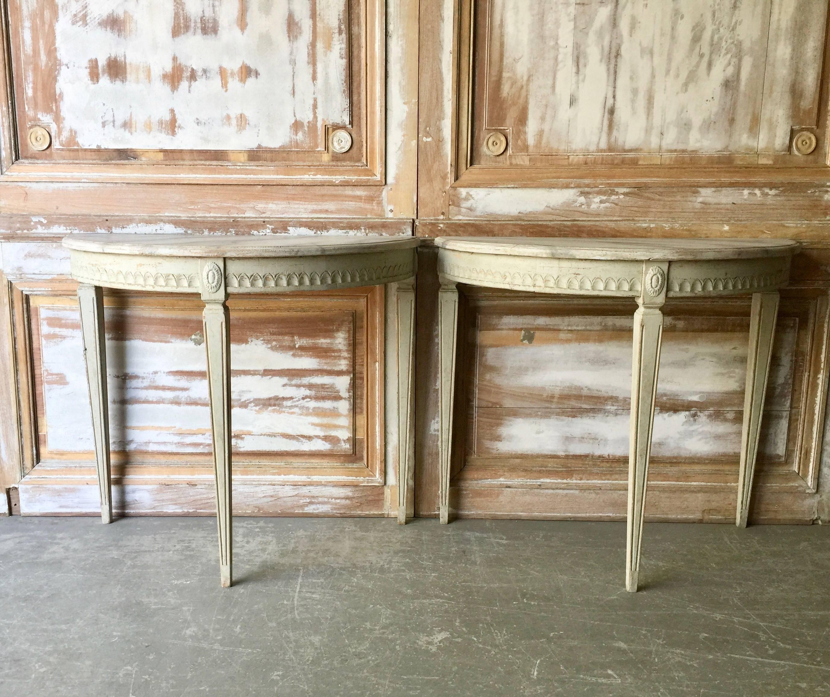 Rare pair of Swedish Gustavian period demilune console tables with marbleized tops and beautifully carved apron on elegant tapered and fluted legs.
Stockholm, Sweden, circa 1810.
More than ever, we selected the best, the rarest, the unusual, the