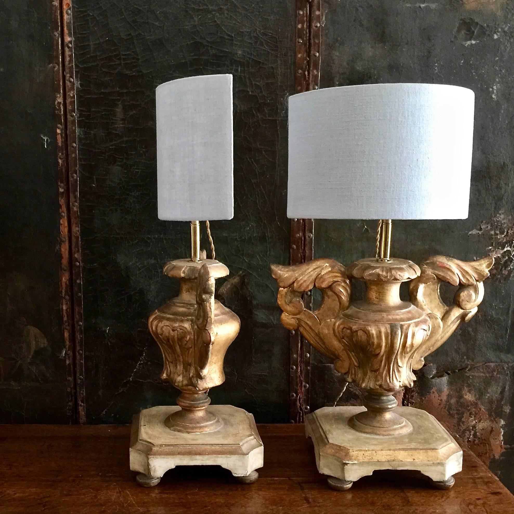 Pair of Italian 18th century candleholders in patinated gold giltwood with beautifully carved urn shape made as lamps with custom-made pale blue color half shape linen shade. Classic and timeless for any decor.
Measures: Shade 12 in W 5 in D