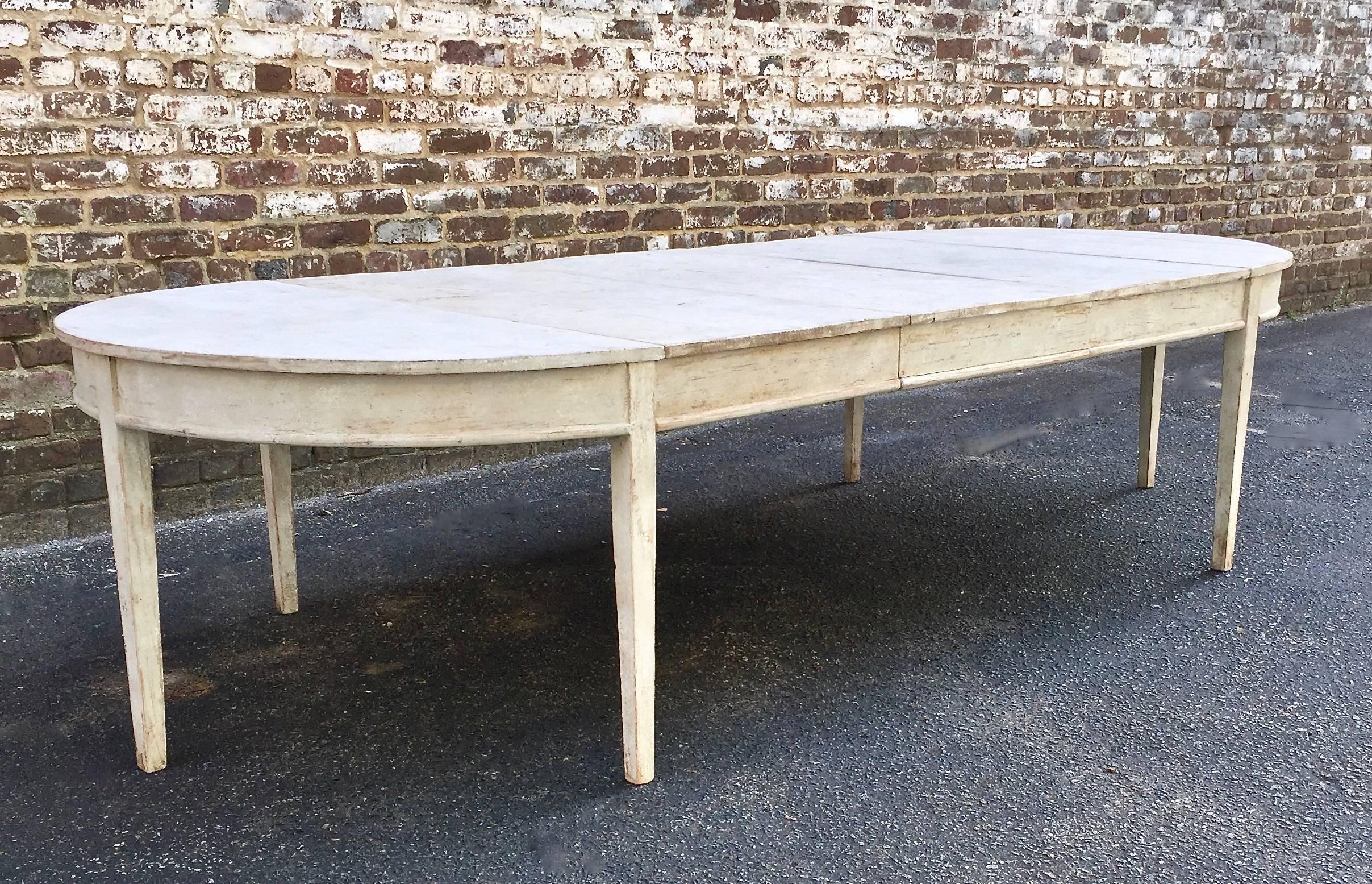 A large and very fine early 19th century Gustavian period extending table with three original leaves and tapered legs. A practical piece that can be used as a pair of console tables, as a round breakfast table or extended with one, two or three