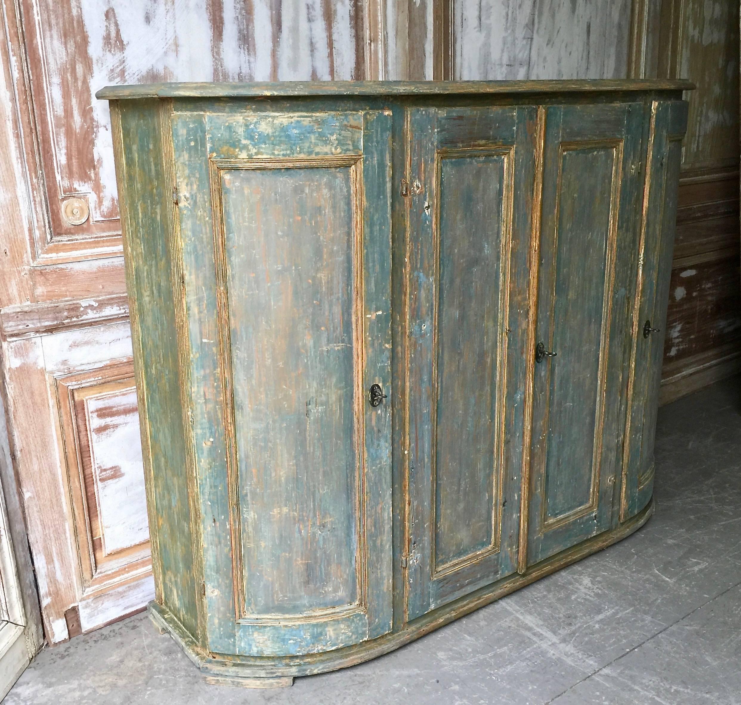 A rare four-door Swedish period Gustavian sideboard with curved panelled doors at each corner, panelled central doors and reeded columns under the shaped top in original worn blue patina.
Dalarna, Sweden, circa 1820
The painted date on the door