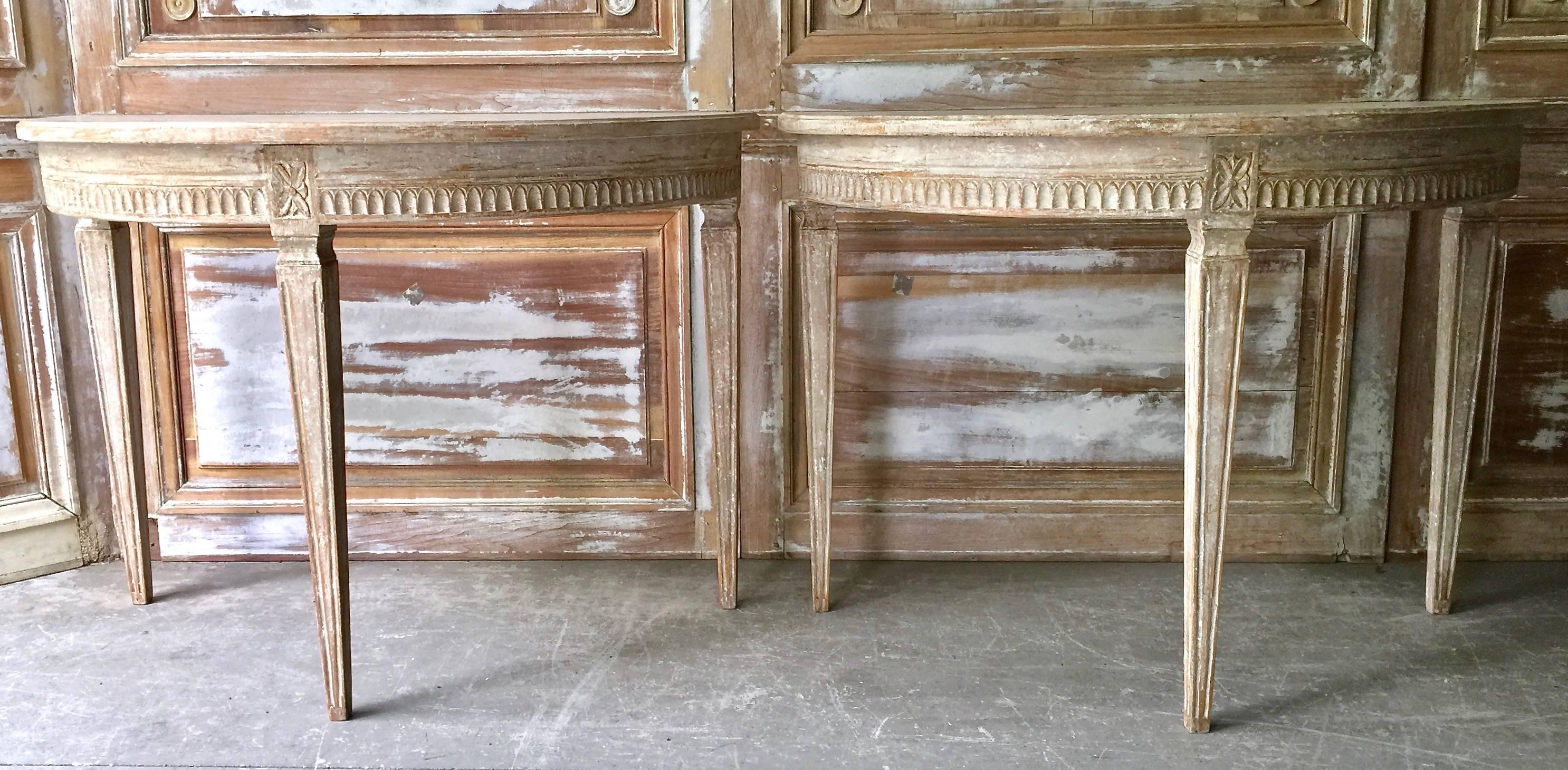 Pair of Swedish Gustavian period demilune console tables beautifully carved apron with Lamb's tongue molding and florets on the corner blocks. Elegant tapered and fluted legs. 
Stockholm, Sweden, circa 1810. 
Here are few examples … surprising