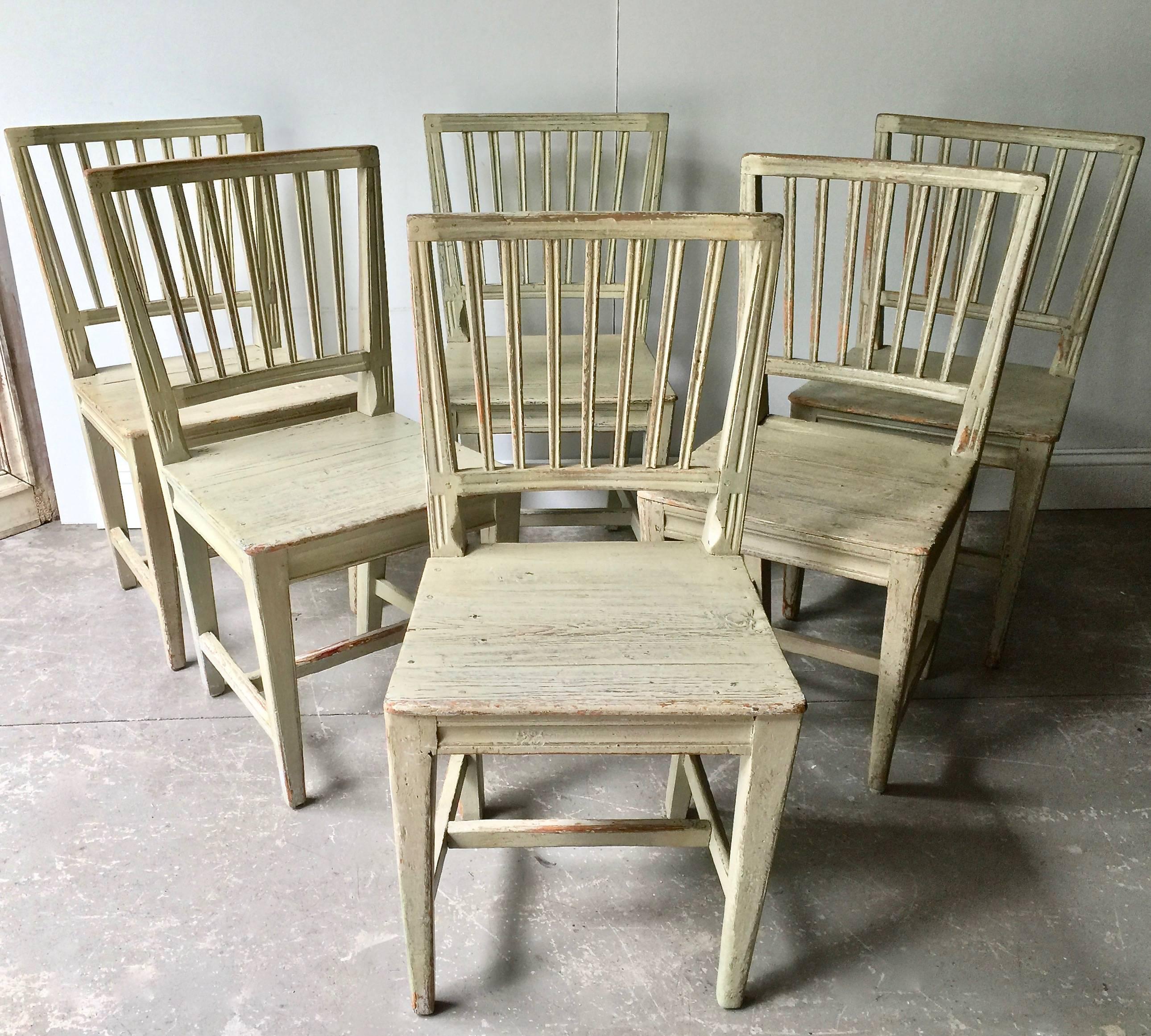 A charming set of six of Swedish 19th century painted Primitive side chairs with simple baluster backs, shaped aprons and straight legs with H-stretchers in time worn greenish patina with traches of bluish paint,
Sweden, 19th century.
Surprising