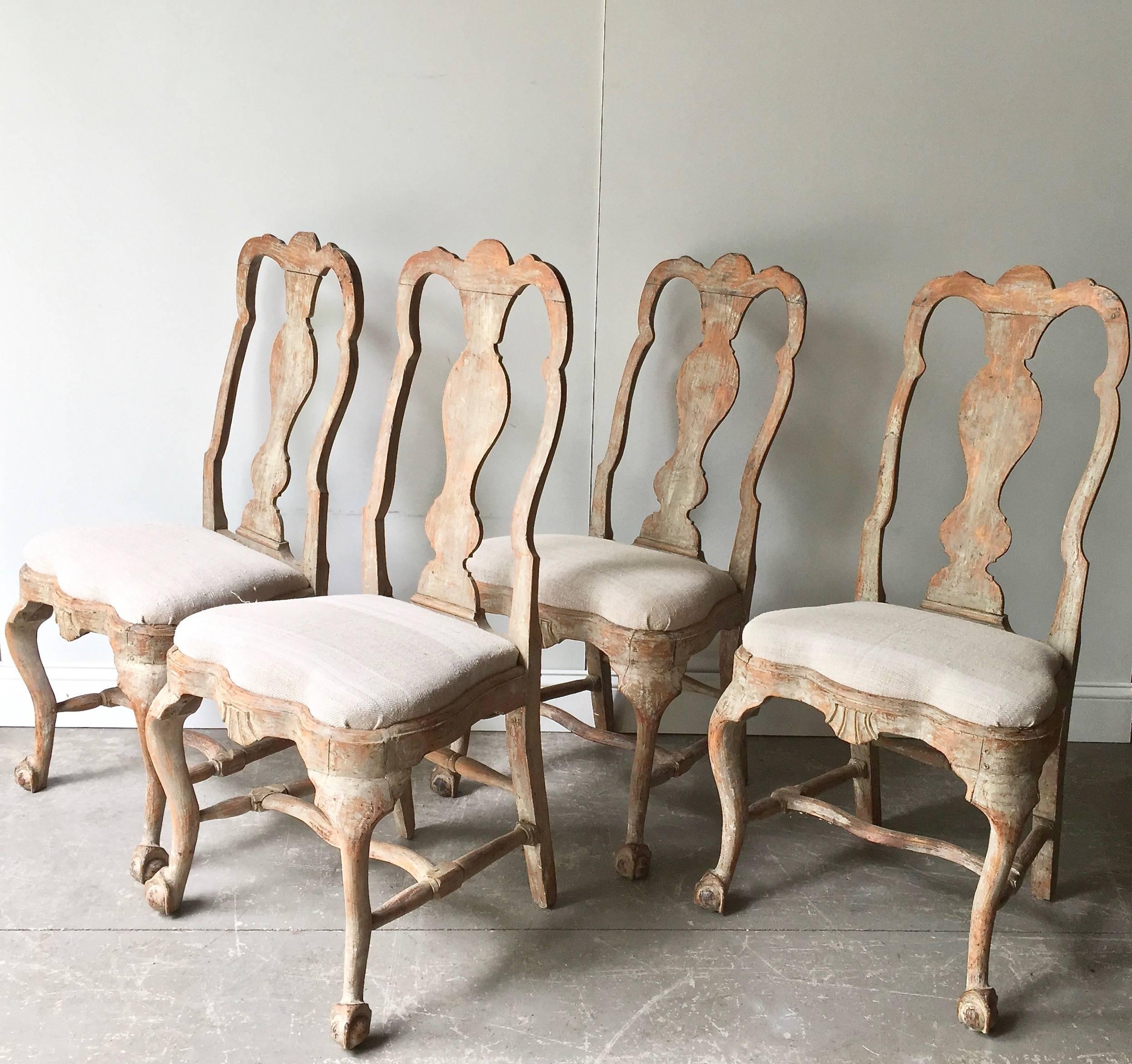 
Set of four elecant18th century Swedish chairs in Rococo period, circa 1760. Lovengly handmade with ritchly carved. Hand scraped back to traces of their original worn paint. Upholstered with antique raw linen. Very elegant chairs, look fantastic