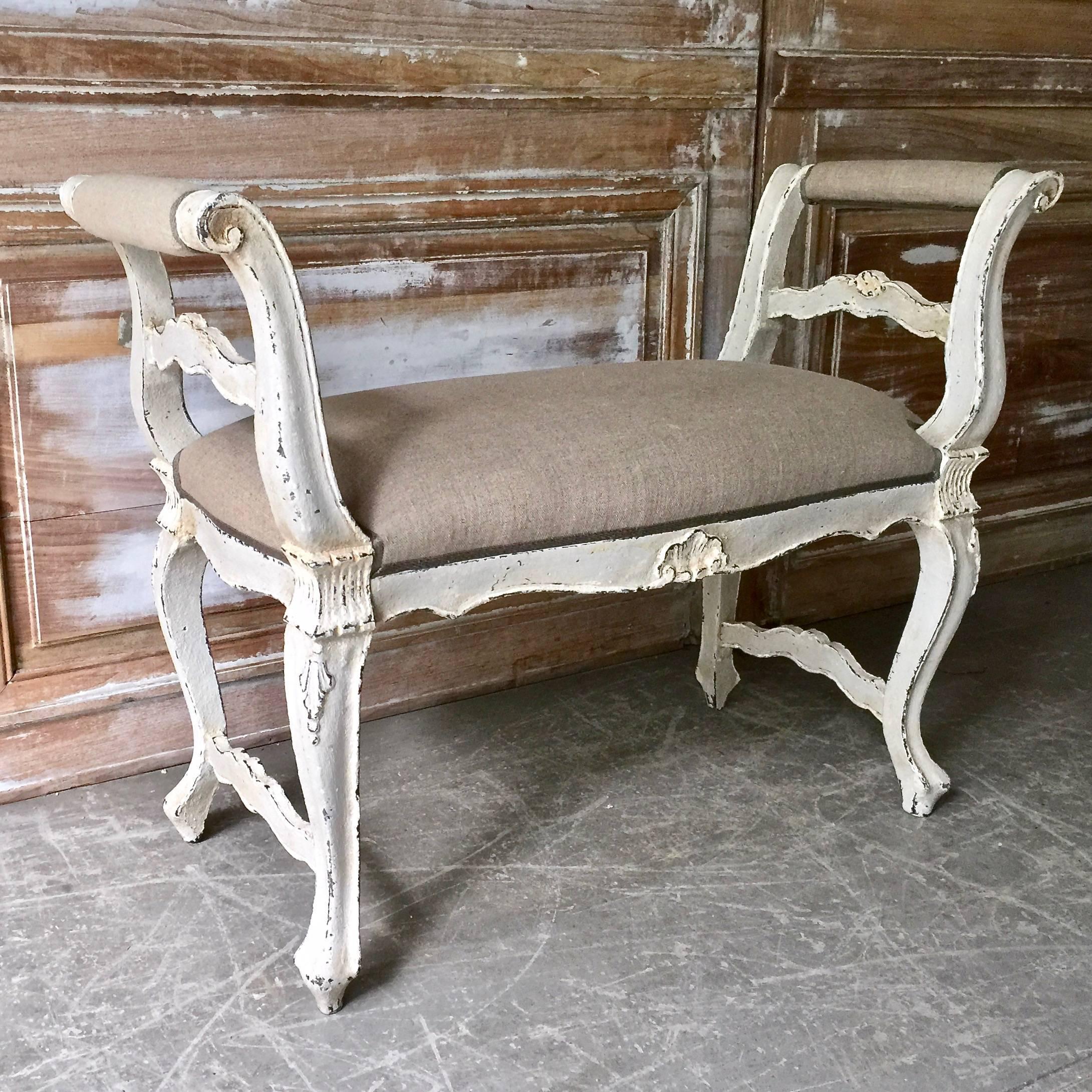 A small, elegant French LXV style banquette with cabriole legs and foliate carving at the knees, armrests and centre of the seat rails, France, circa 1900.
 