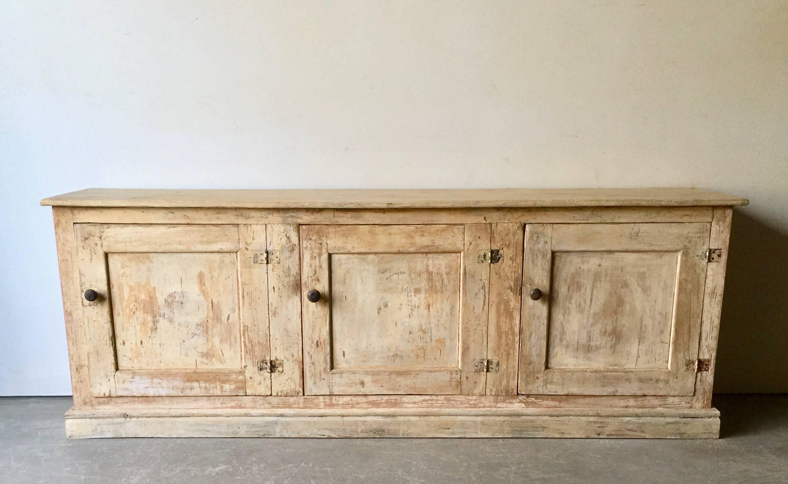 A large three door 19th century Italian sideboard in original lot of time worn patina with amble storage.
 Surprising pieces and objects, authentic, decorative and rare items. Discover them all.