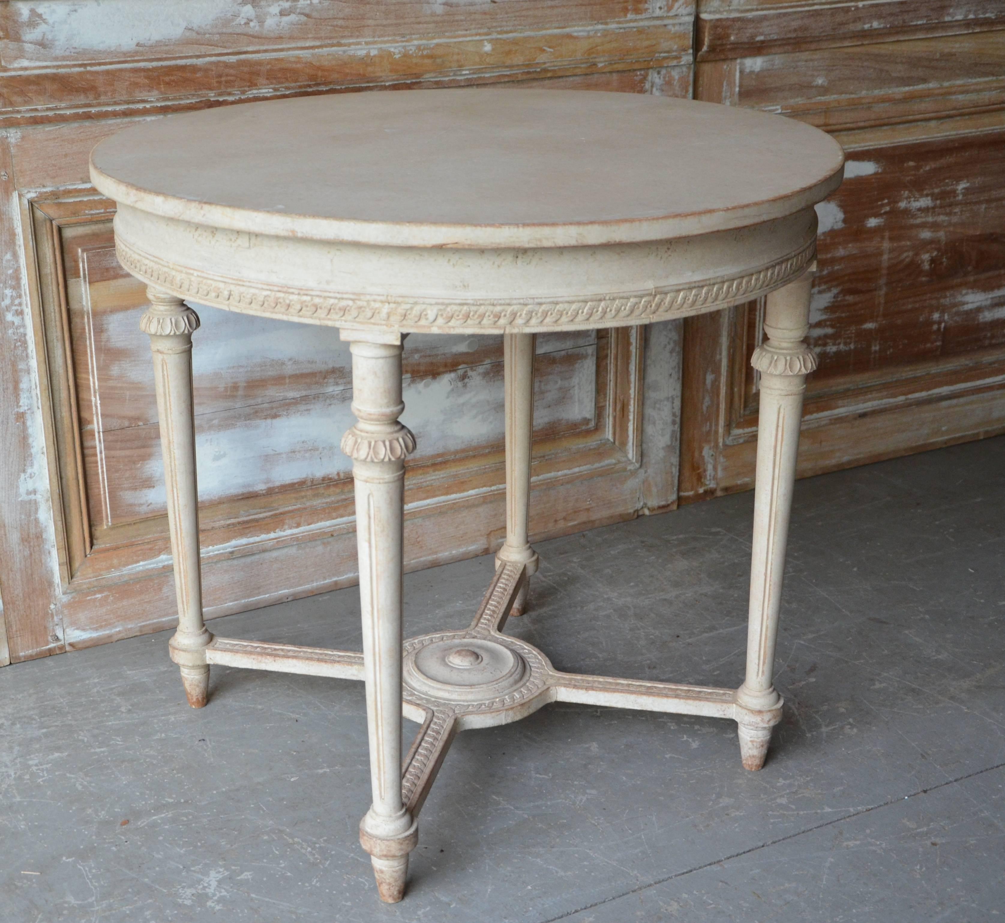 Swedish Gustavian style round table with richly carved apron, tapering carved legs and saltire strecher with central medallion in painted worn cream patina.
Stockholm, Sweden circa 1880