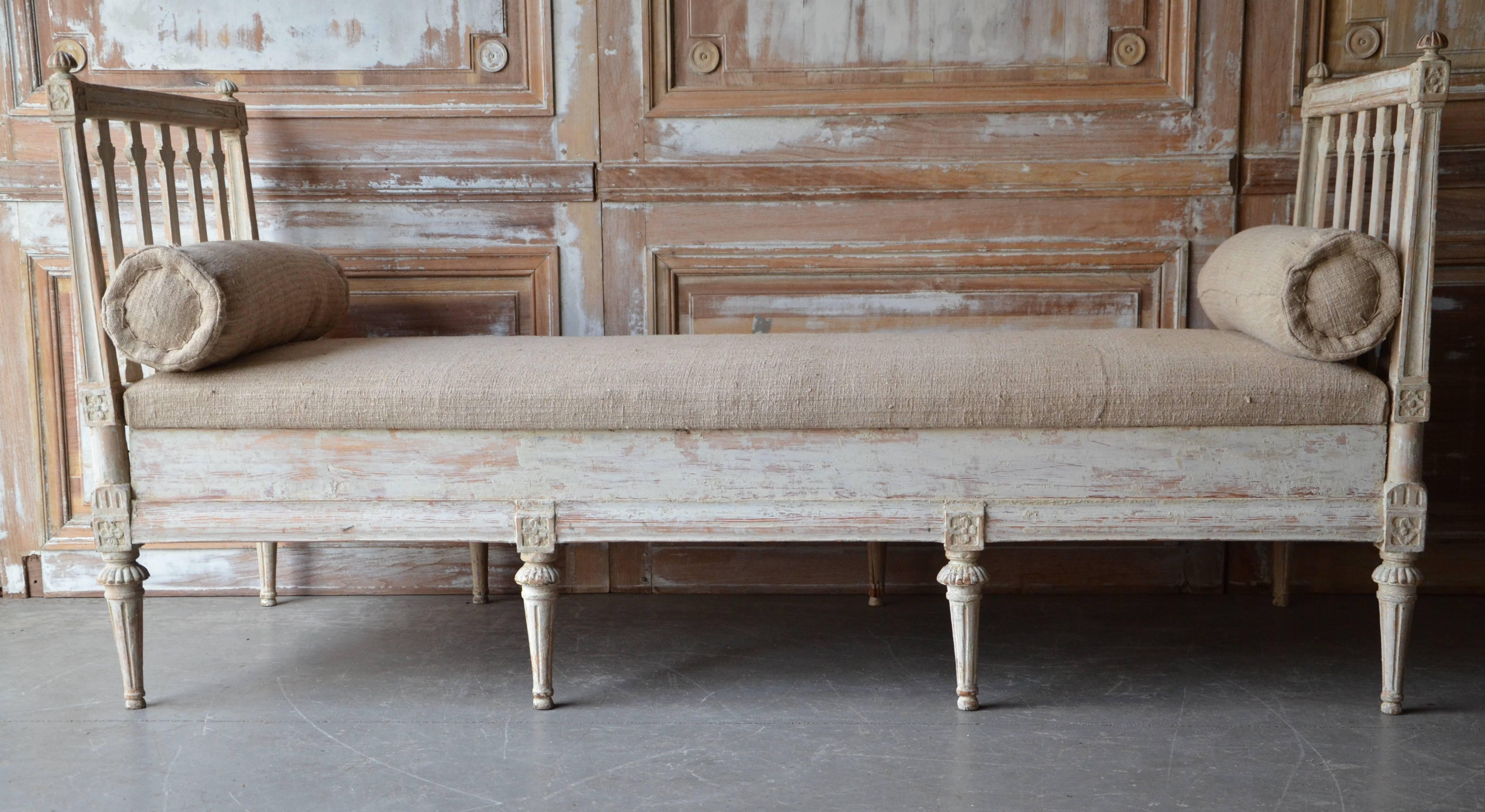 
Late 18th century richly carved Swedish Gustavian daybed has a special seat; its a covered wooden seat. It's a trunk feeling when you open it.
The irons on the side are original and typical for that period 1790-1800.
We always love it when they