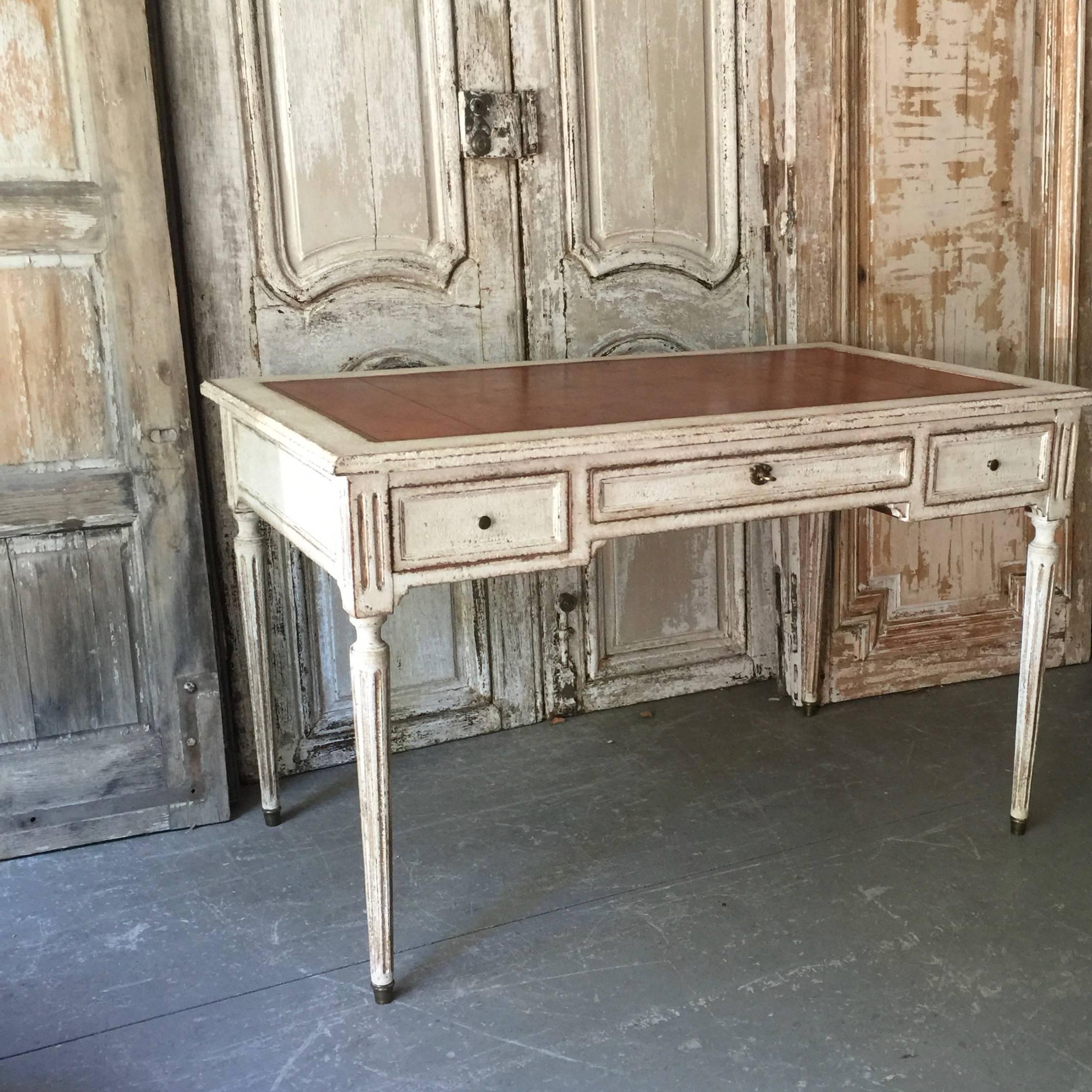 Elegant 19th century French Louis XVI style Bureaux plat with drawers and leather top with nicely stamped and gold leafed embossing design. The back of the desk is trimmed to match the front in faux partner desk style.
Kneehole: 24” H.
France,