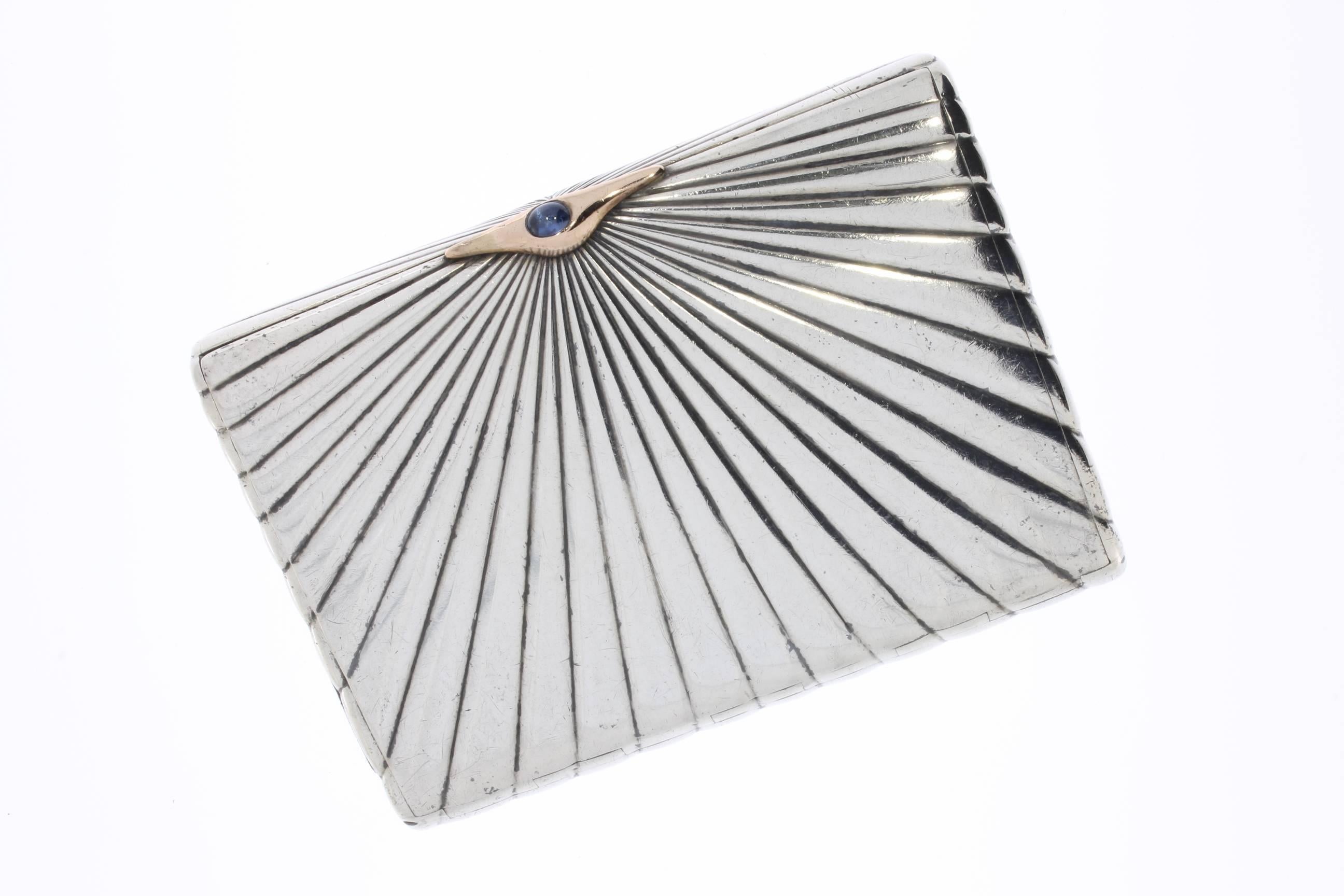 This Art Deco French sterling silver cigarette case was manufactured 1920s. Square shaped. Partial gilded. The lid has a snap lock with cabochon-cut sapphire. Hallmarked inside: Diana head, 84 BC. Total weight: 169.8 g.
The dimensions are 2.68 x
