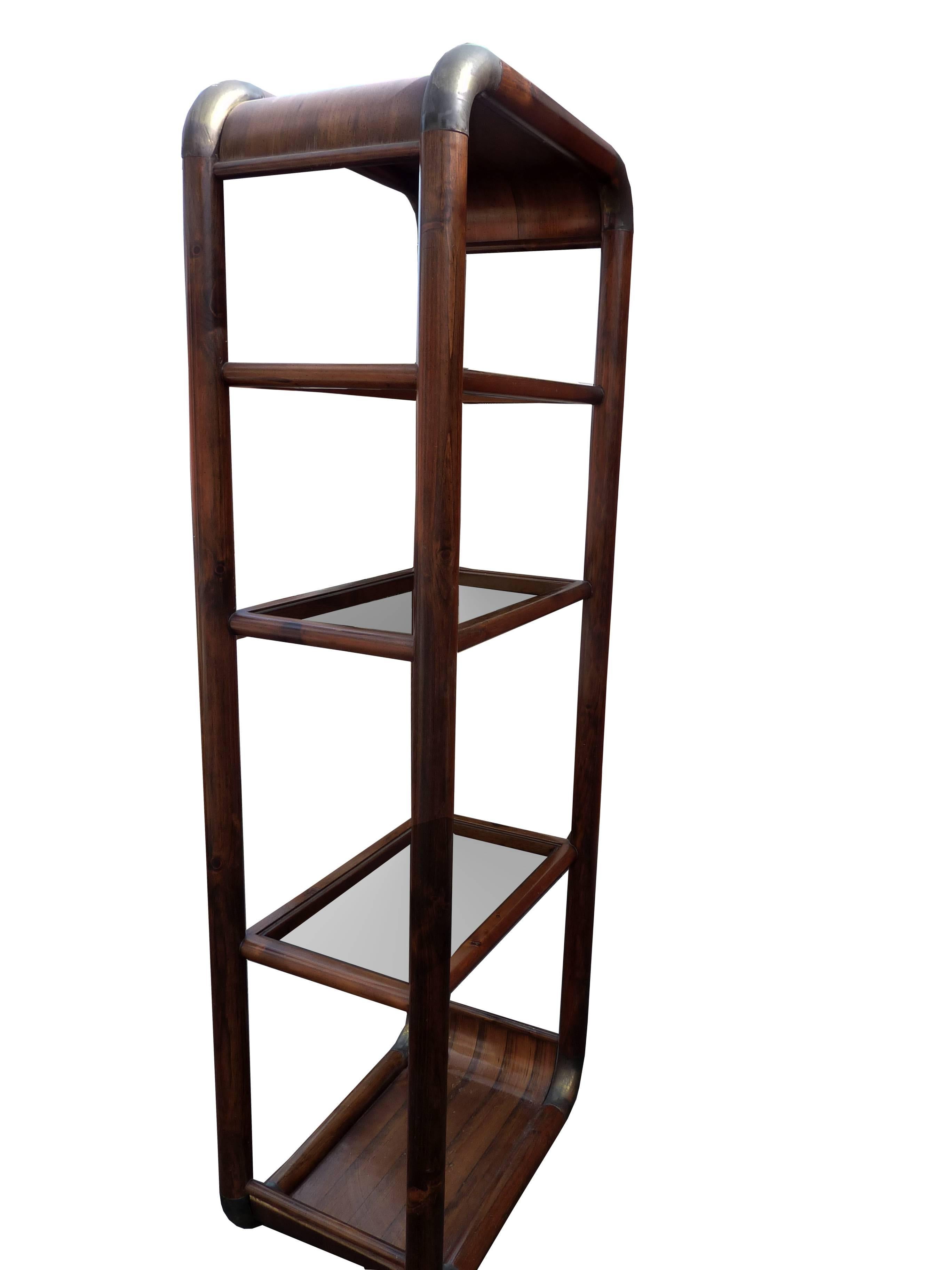 Stunning vintage Mid-Century etagere in walnut wood with handcrafted details brass in the corners and glass shelves.