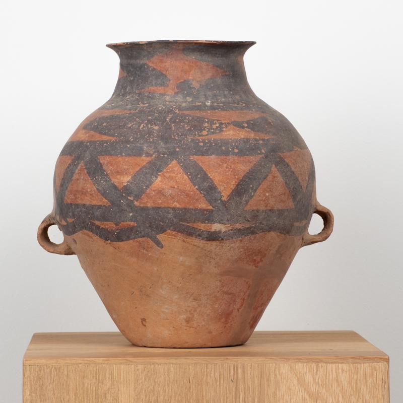 Neolithic Period, 3rd Millennium B.C. Chinese Painted Terracotta Storage Jar
An elegant Chinese terracotta storage jar from the Neolithic period, dating to the 3rd millennium B.C. The vessel features a piriform body with a wide, flaring mouth and